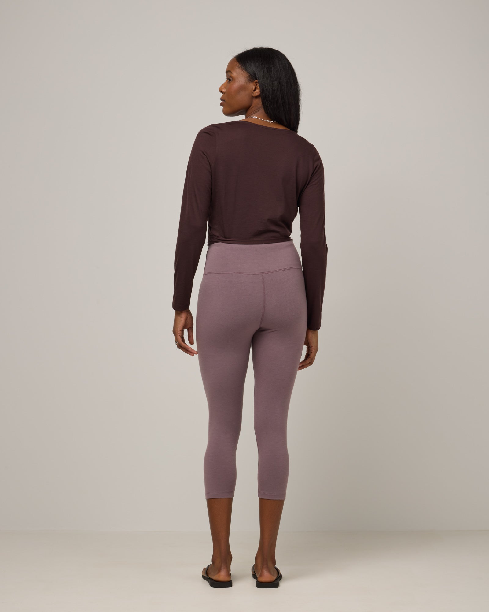 Model wearing Summit Crop Legging in Lavender, a dusky muted purple color. Summit Crop Legging is a merino wool legging available in sizes XS-3X.