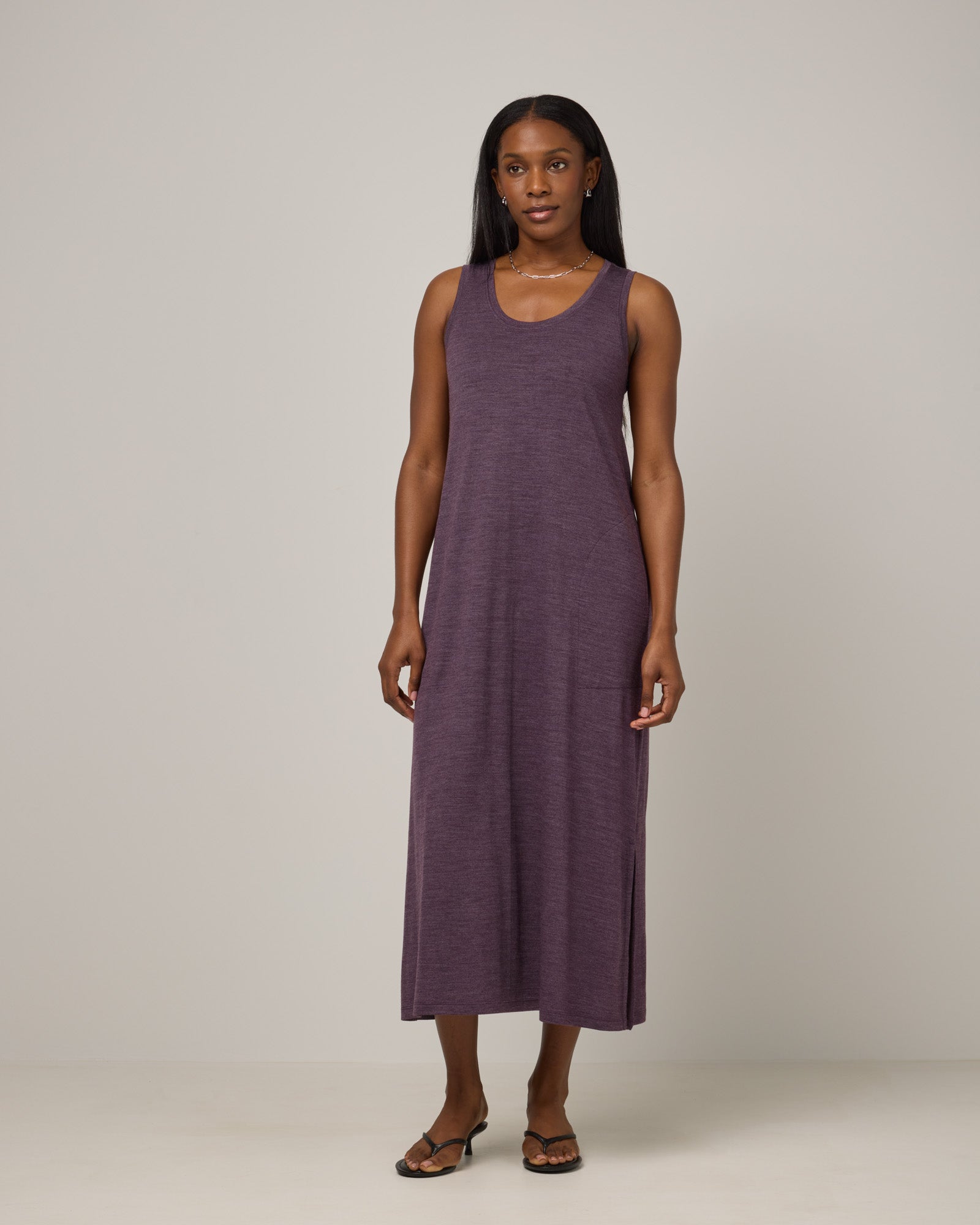 Model wearing Audrey TENCEL™ Maxi Dress in Marionberry Heather, a deep berry purple color. Audrey TENCEL™ Maxi Dress is a merino wool sleeveless, scoop neck, maxi shift dress with pockets available in sizes XS-3X.