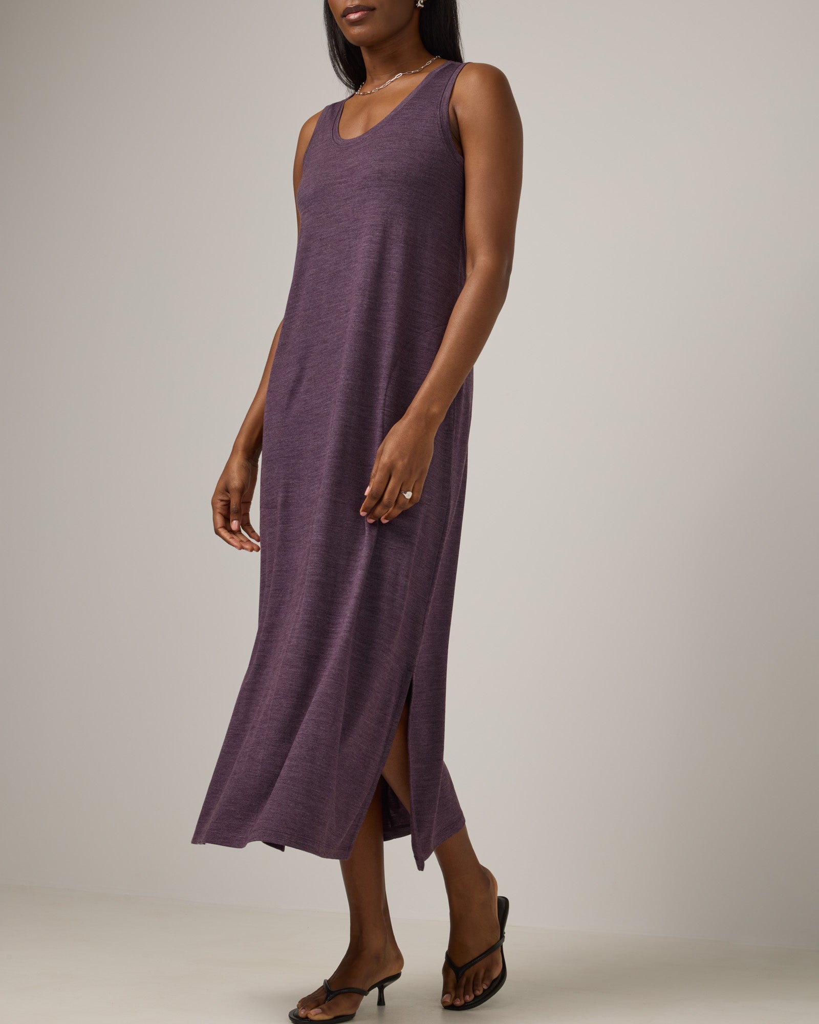 Model wearing Audrey TENCEL™ Maxi Dress in Marionberry Heather, a deep berry purple color. Audrey TENCEL™ Maxi Dress is a merino wool sleeveless, scoop neck, maxi shift dress with pockets available in sizes XS-3X.