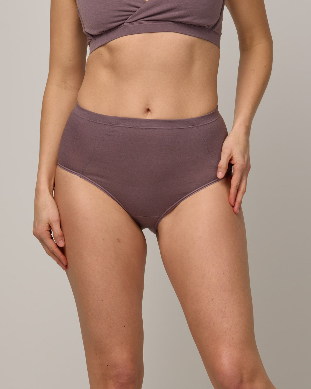 Model wearing Roam High Waist Bikini in Lavender, a dusky muted purple color. Roam High Waist Bikini is a merino wool underwear available in sizes XS-3X.