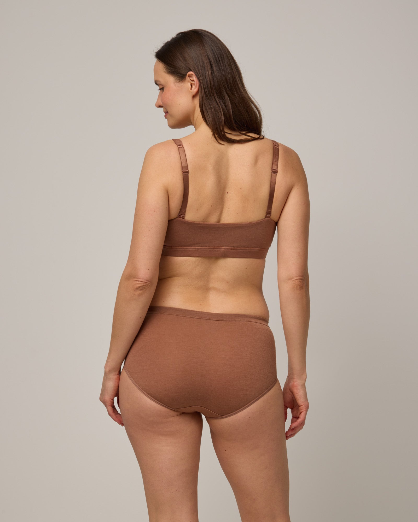Model wearing Roam High Waist Bikini & Convertible Wrap Bra in Mocha Brown, a medium-dark nude color. Roam High Waist Bikini is a merino wool underwear available in sizes XS-3X.