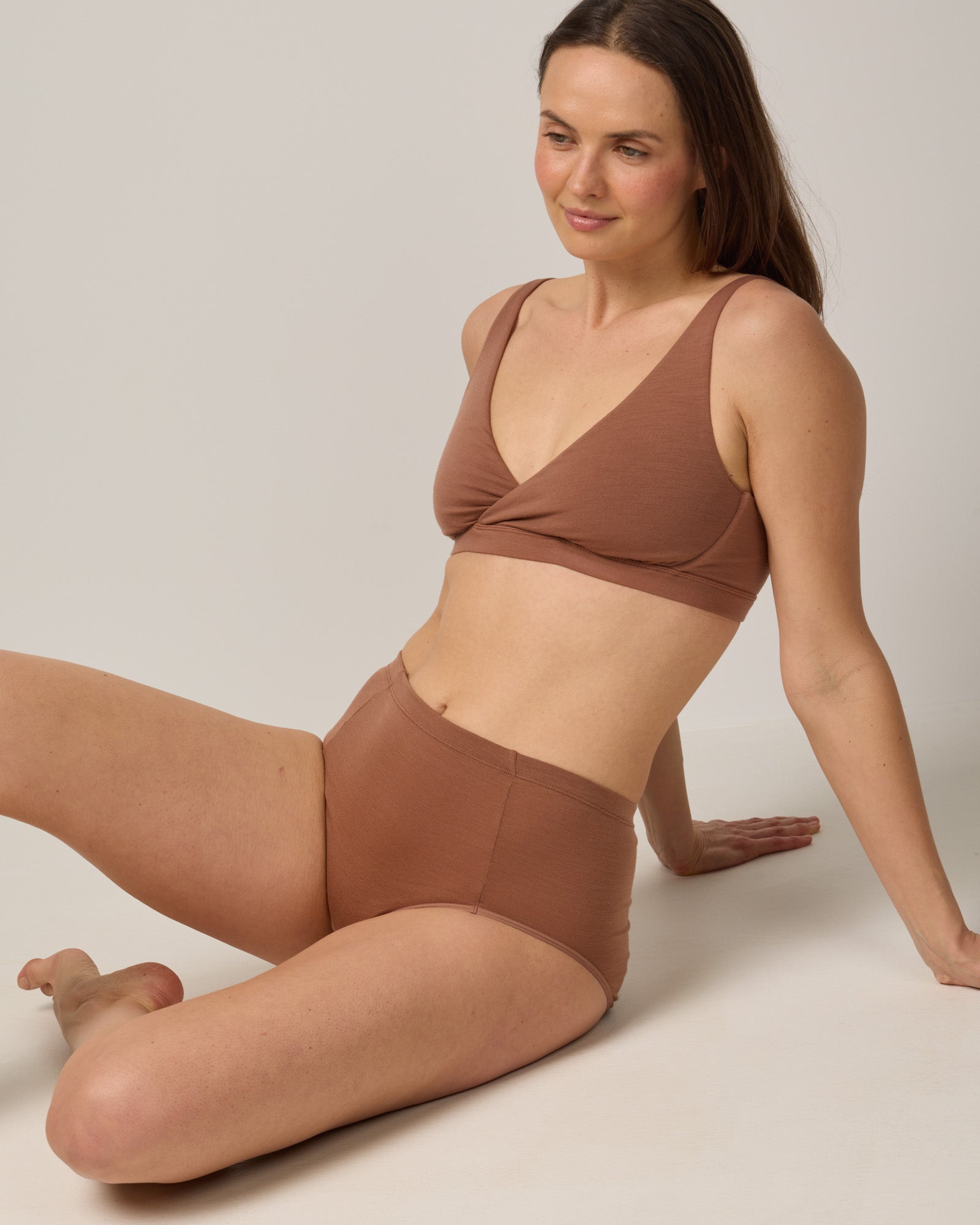 Model wearing Roam High Waist Bikini & Convertible Wrap Bra in Mocha Brown, a medium-dark nude color. Roam High Waist Bikini is a merino wool underwear available in sizes XS-3X.