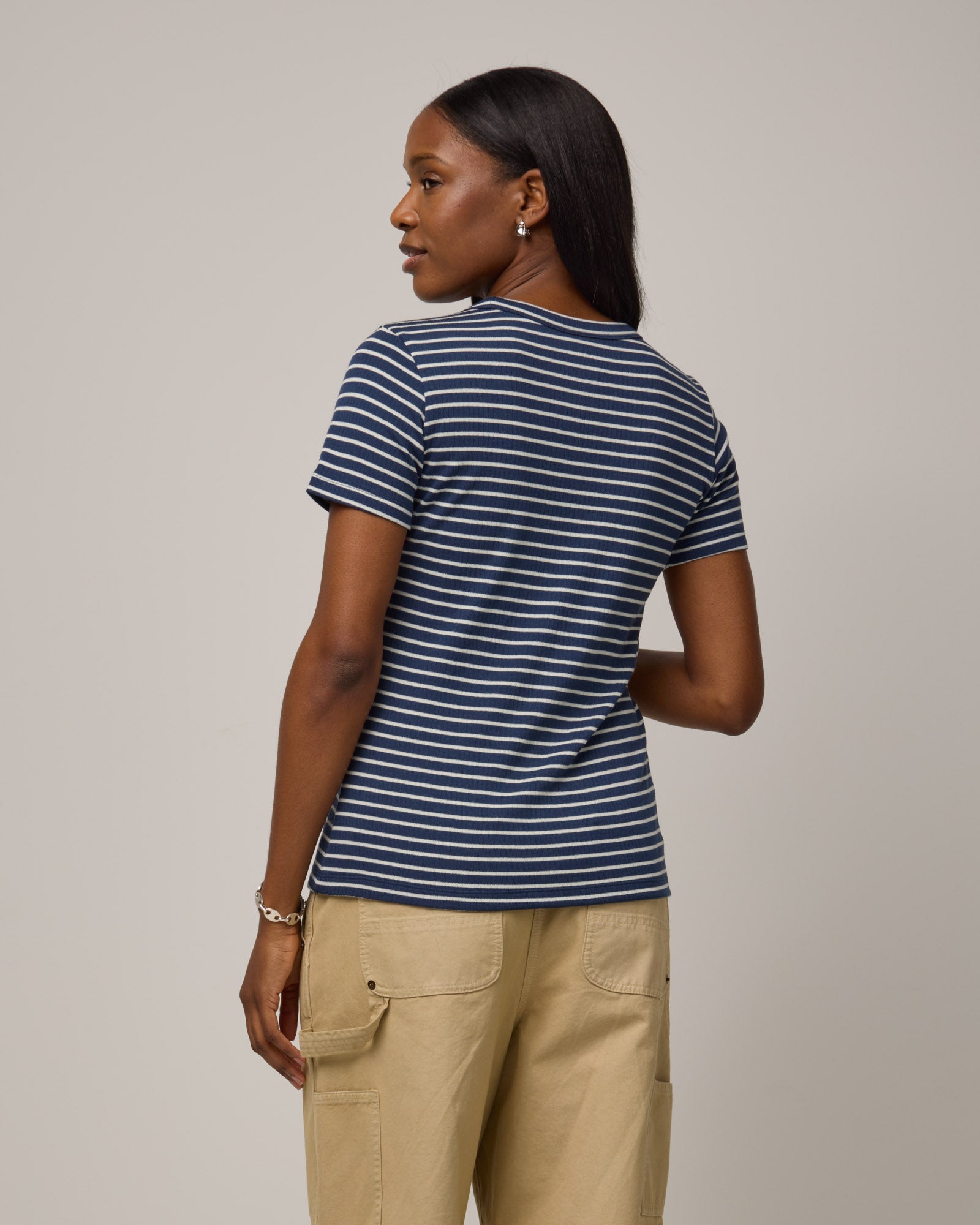 Model wearing Taylor Ribbed Tee in Marine Blue & Natural White Stripe. Taylor Ribbed Tee is a merino wool short sleeve, crew neck tee available in sizes XS-3X.
