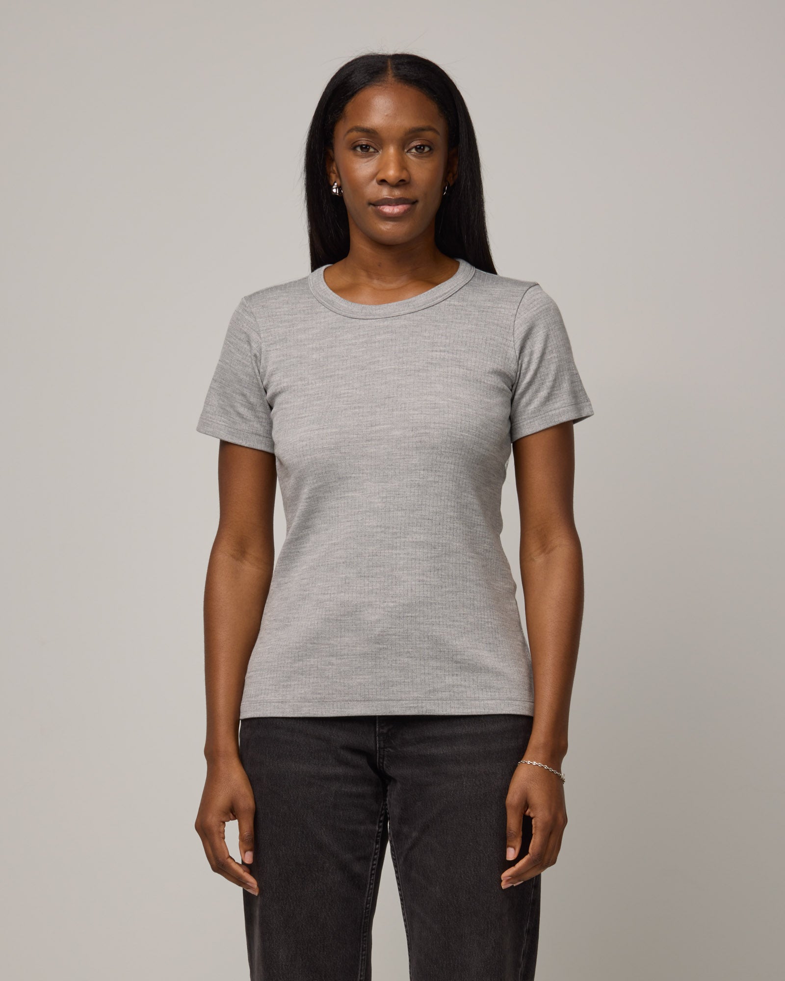 Model wearing Taylor Ribbed Tee in Gray Heather. Taylor Ribbed Tee is a merino wool short sleeve crew neck tee available in sizes XS-3X.