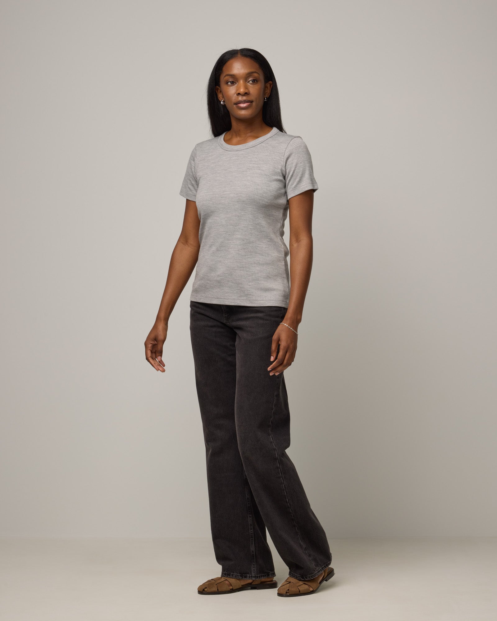Model wearing Taylor Ribbed Tee in Gray Heather. Taylor Ribbed Tee is a merino wool short sleeve crew neck tee available in sizes XS-3X.