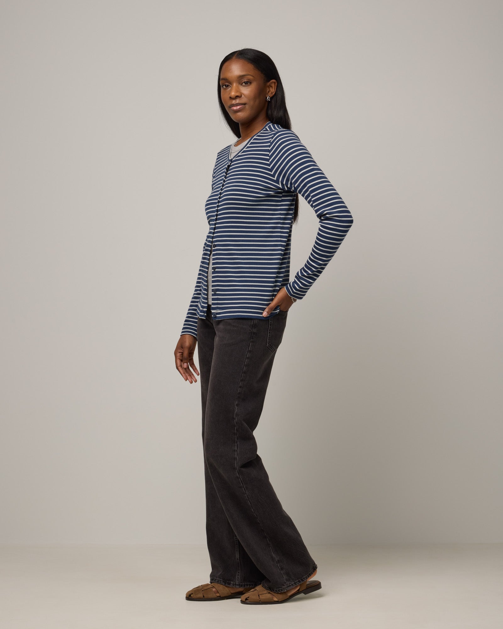 Model wearing Celeste Ribbed Cardigan in Marine Blue & Natural White Stripe. Celeste Ribbed Cardigan is a merino wool long sleeve, crew neck cardigan available in sizes XS-3X.