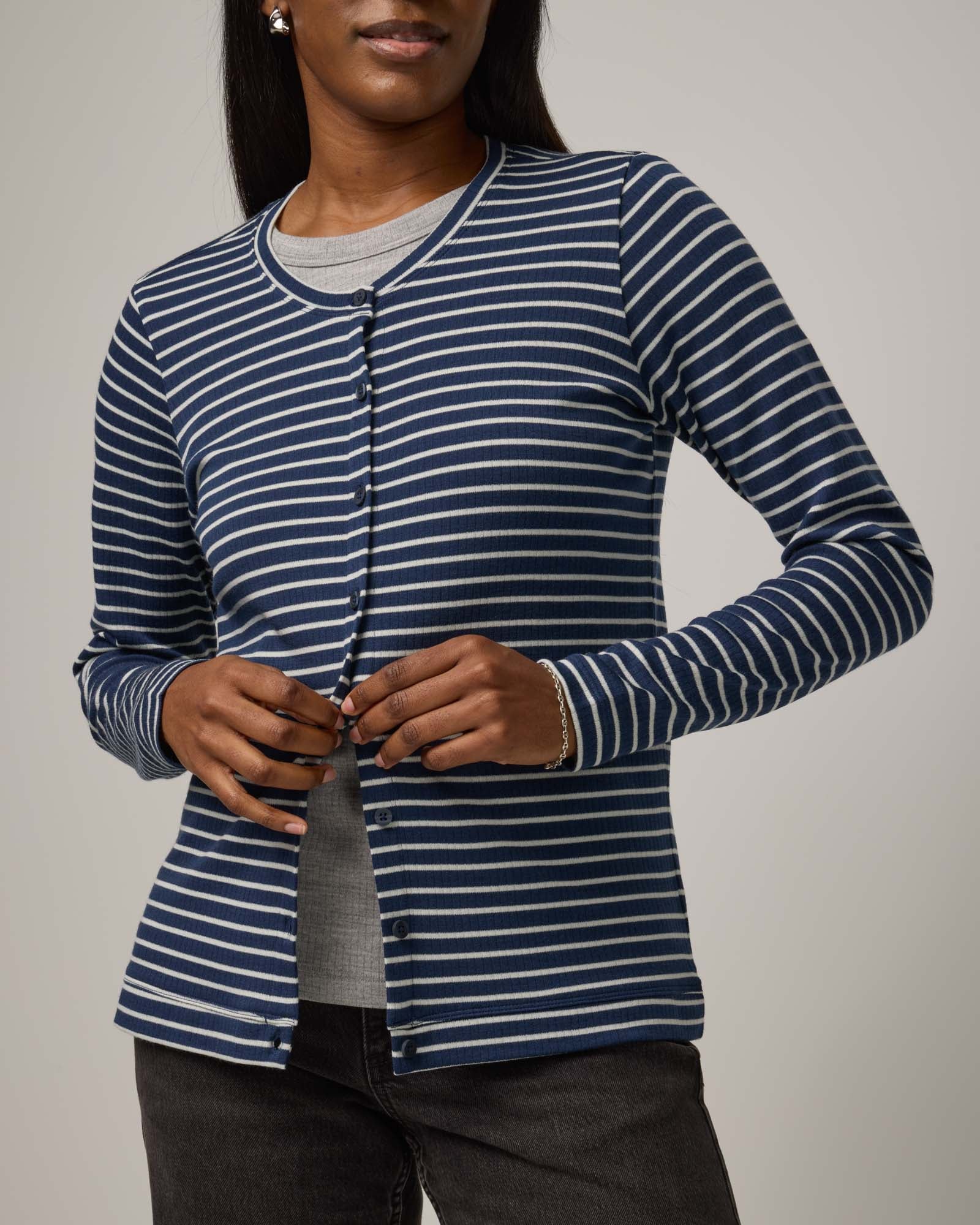 Model wearing Celeste Ribbed Cardigan in Marine Blue & Natural White Stripe. Celeste Ribbed Cardigan is a merino wool long sleeve, crew neck cardigan available in sizes XS-3X.