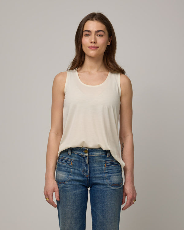 Model wearing Steph Scoop Neck Tank in Natural White. Steph Scoop Neck Tank is a merino wool sleeveless tank available in sizes XS-3X.  