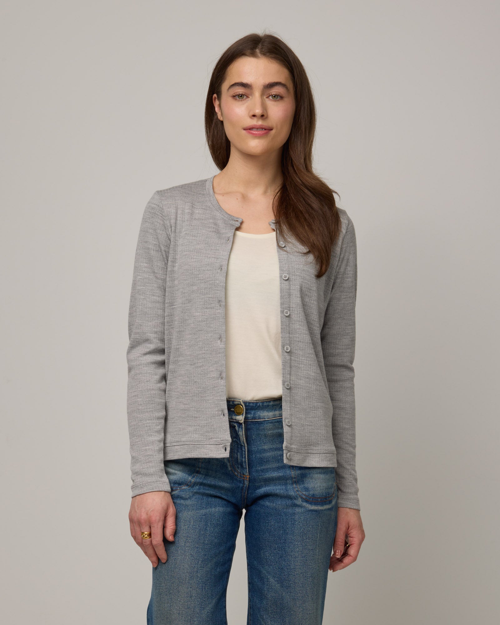 Model wearing Celeste Ribbed Cardigan in Gray Heather. Celeste Ribbed Cardigan is a merino wool long sleeve, crew neck cardigan available in sizes XS-3X.