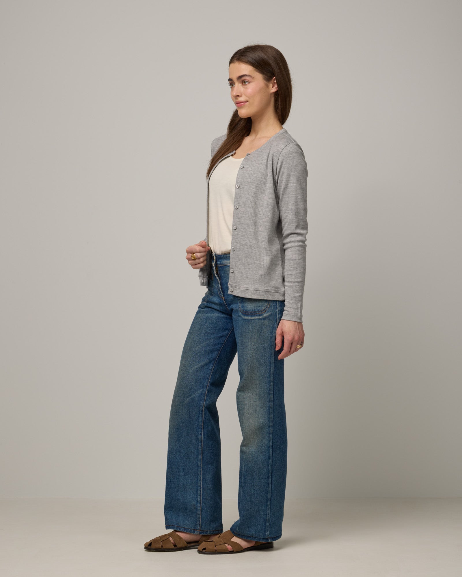 Model wearing Celeste Ribbed Cardigan in Gray Heather. Celeste Ribbed Cardigan is a merino wool long sleeve, crew neck cardigan available in sizes XS-3X.