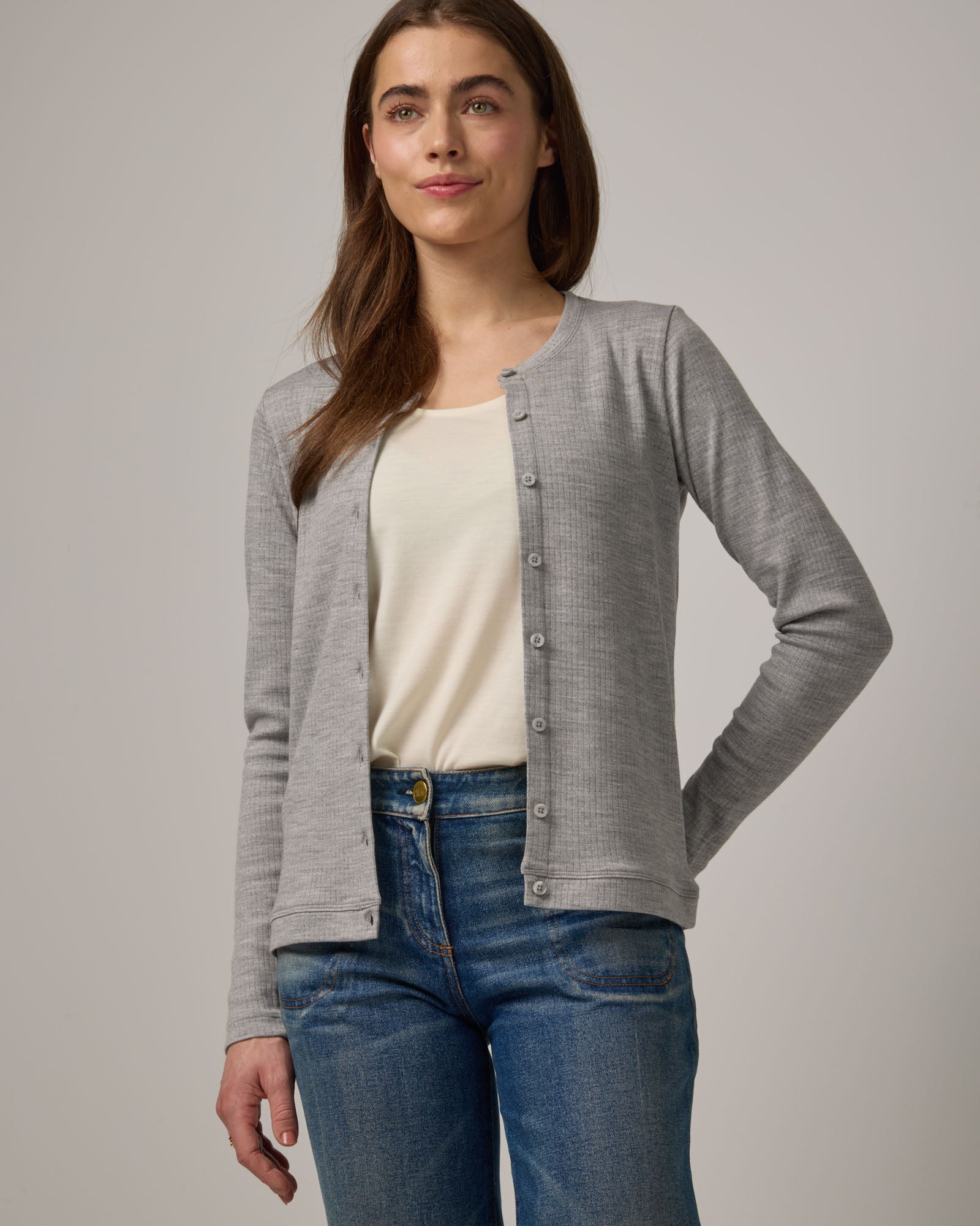 Model wearing Celeste Ribbed Cardigan in Gray Heather. Celeste Ribbed Cardigan is a merino wool long sleeve, crew neck cardigan available in sizes XS-3X.
