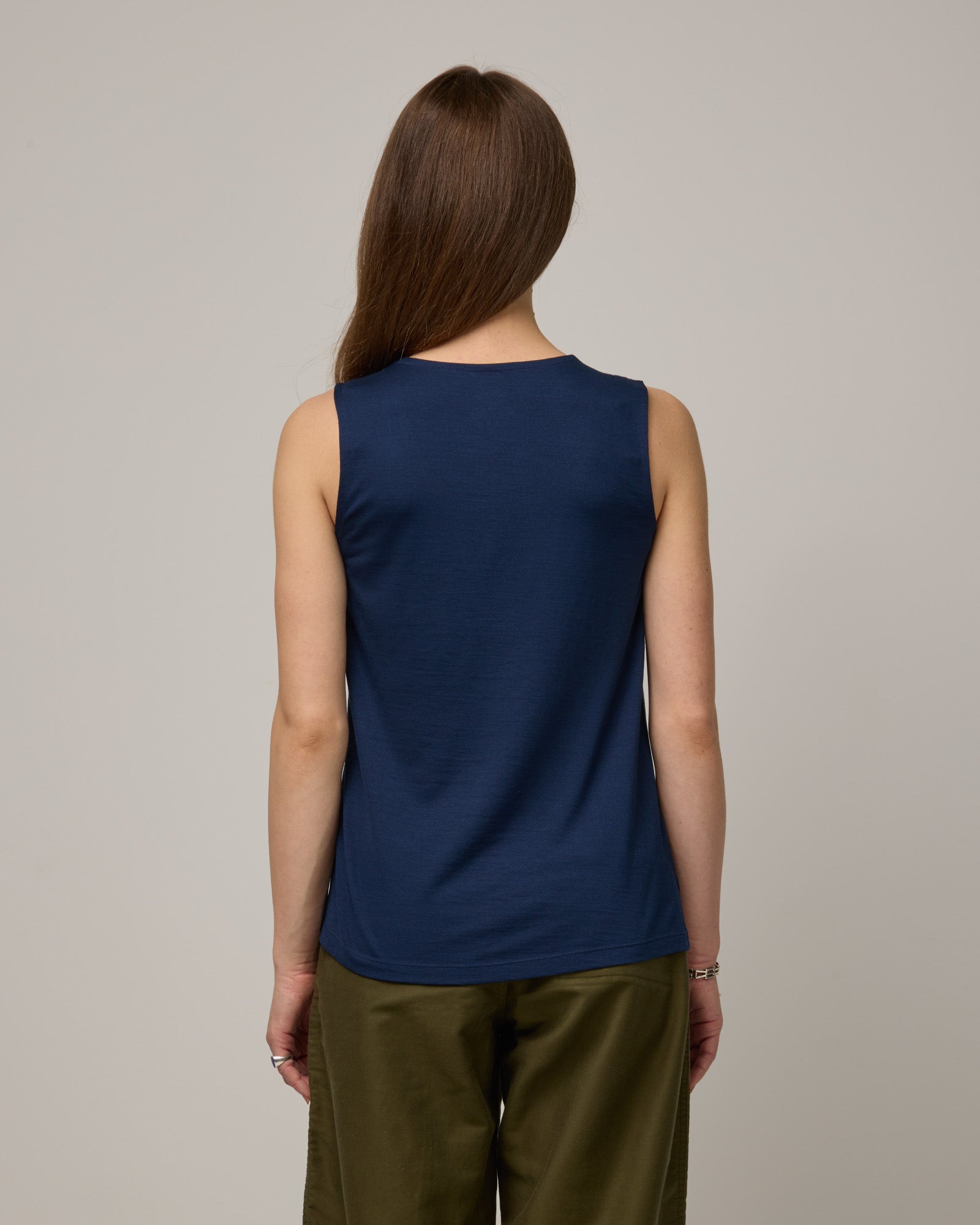 Model wearing Steph Scoop Neck Tank in Marine Blue, a deep royal blue color. Steph Scoop Neck Tank is a merino wool sleeveless tank available in sizes XS-3X.