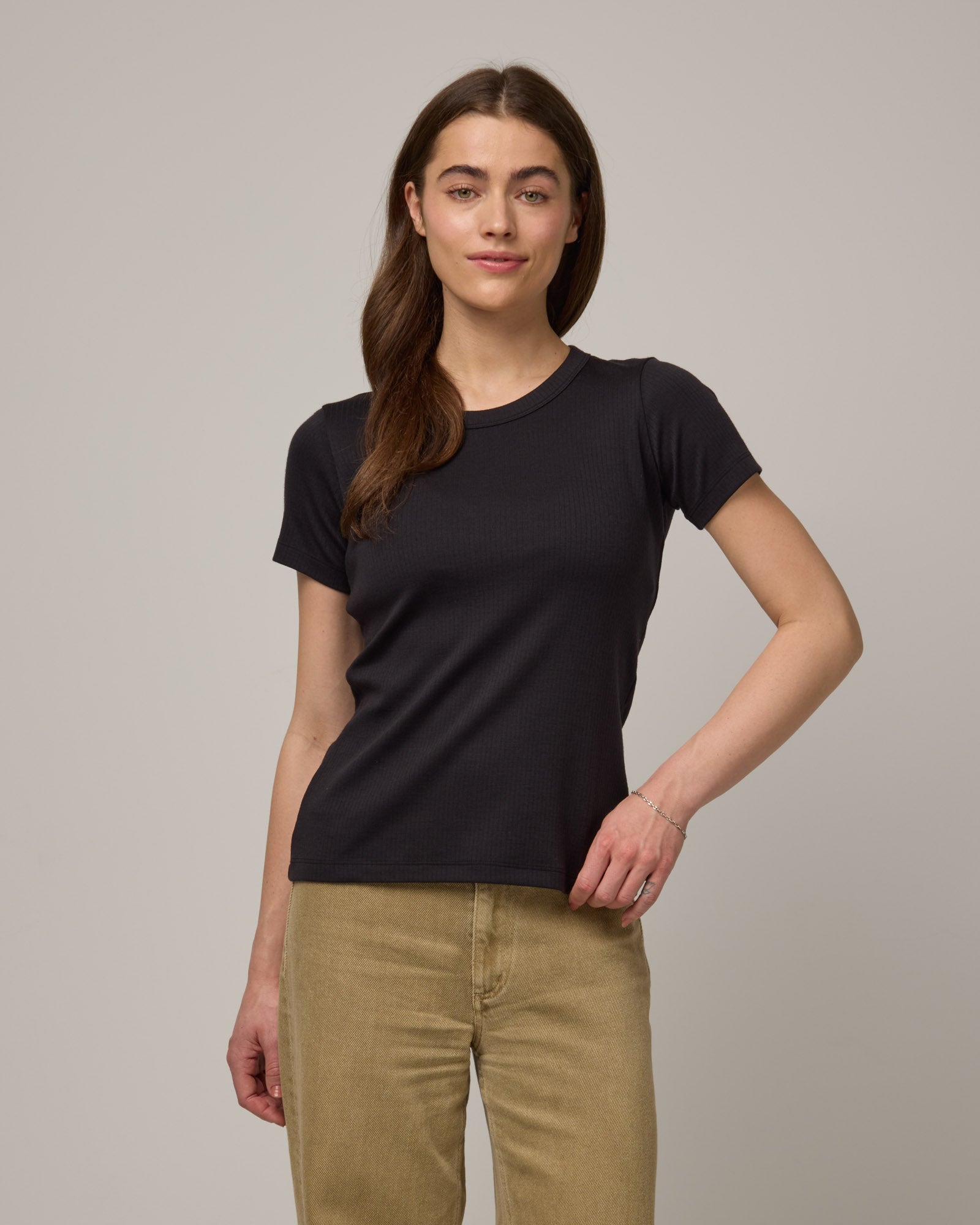 Model wearing Taylor Ribbed Tee in Black. Taylor Ribbed Tee is a merino wool short sleeve, crew neck tee available in sizes XS-3X. 