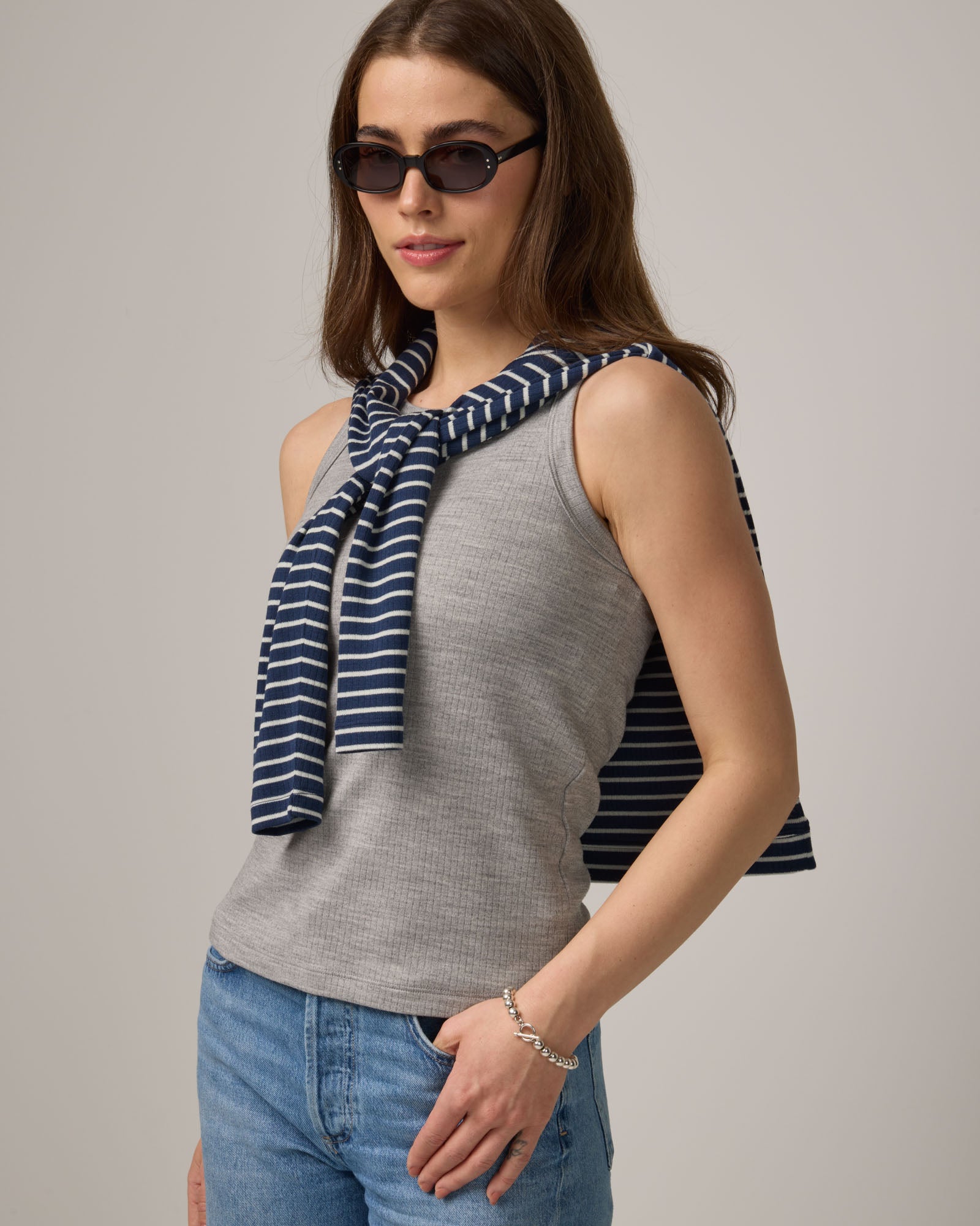 Model wearing Lily Ribbed Tee in Gray Heather. Lily Ribbed Tee is a merino wool sleeveless, crew neck tank available in sizes XS-3X. 