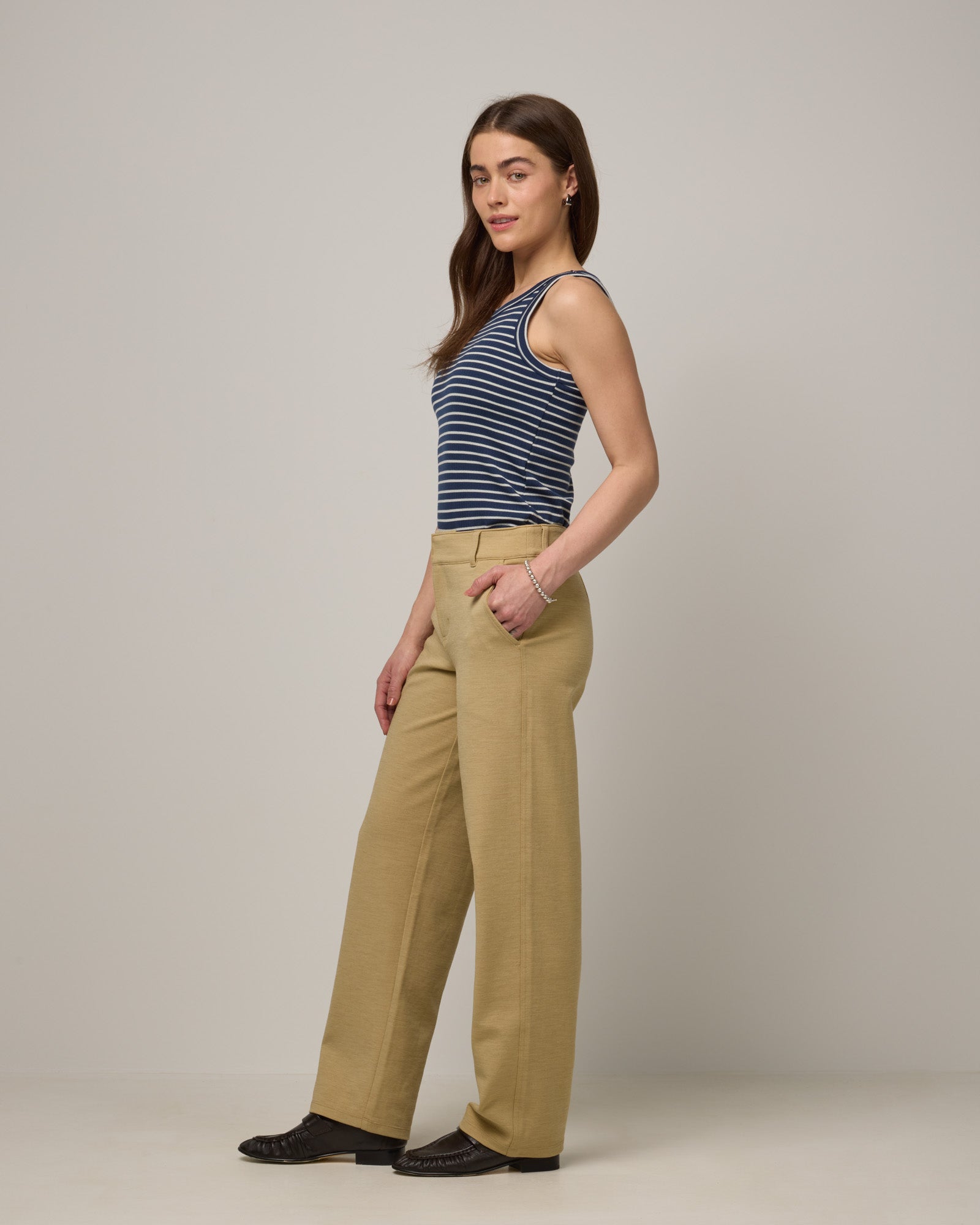 Model wearing Lily Ribbed Tee in Marine Blue & Natural White Stripe. Lily Ribbed Tee is a merino wool sleeveless, crew neck tank available in sizes XS-3X. 