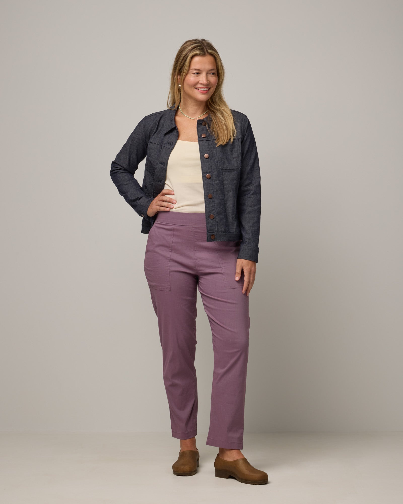 Model wearing Canyon Straight Leg Pant in Lavender. Canyon Straight Leg Pant is a merino wool pant with pockets available in sizes XS-3X Regular and XS-XXL Long.