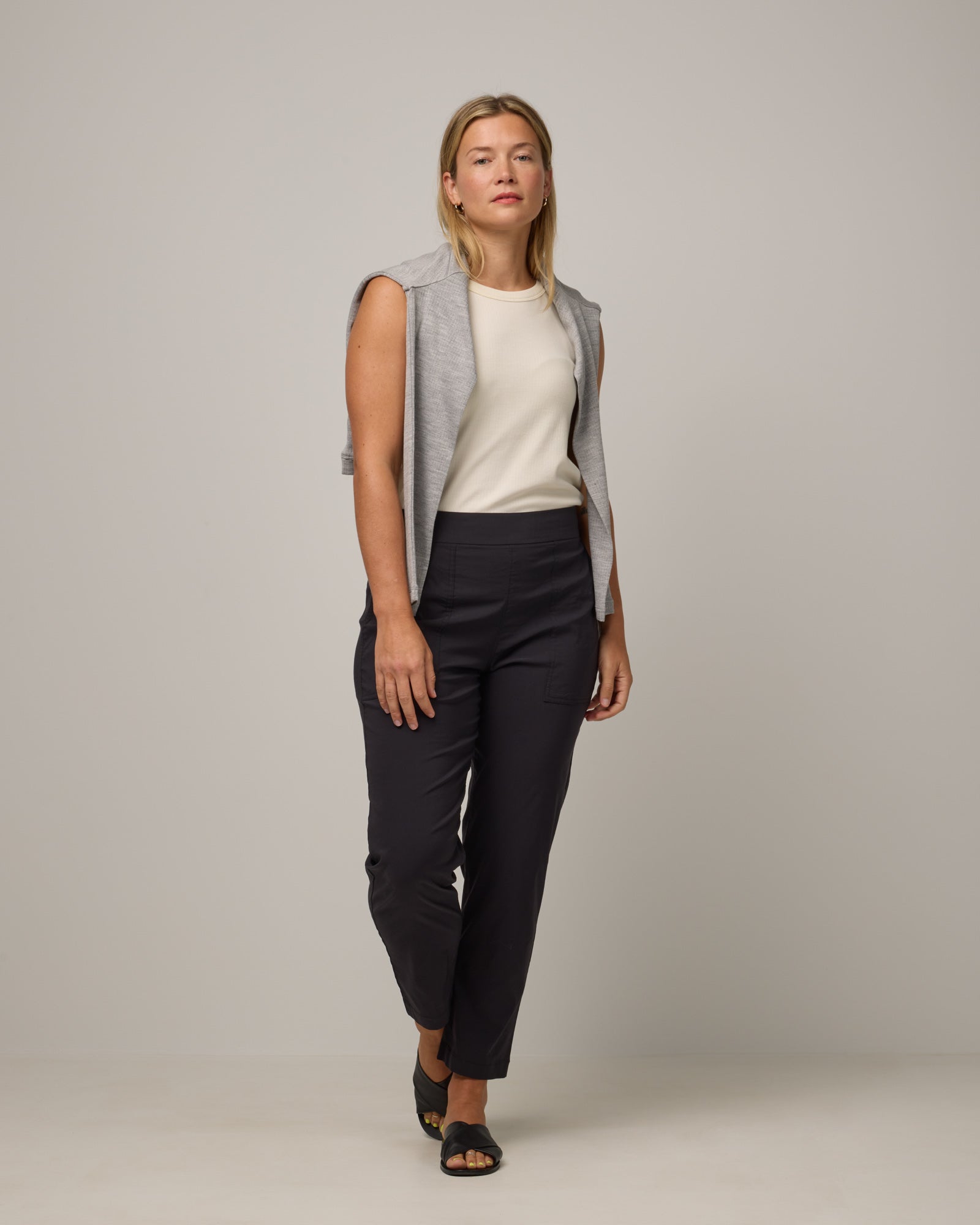 Model wearing Canyon Straight Leg Pant in Black. Canyon Straight Leg Pant is a merino wool pant with pockets available in sizes XS-3X Regular and XS-XXL Long.