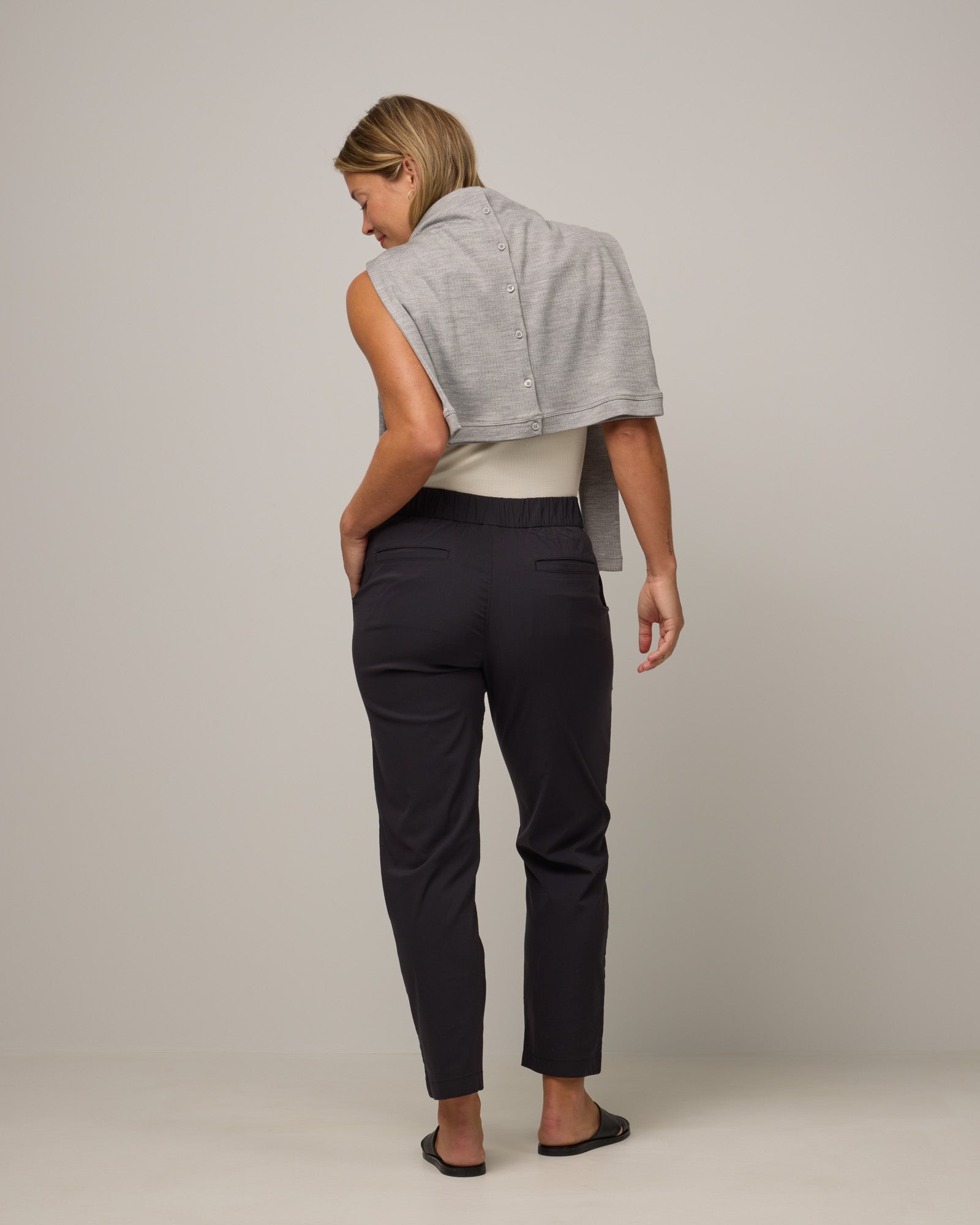 Model wearing Canyon Straight Leg Pant in Black. Canyon Straight Leg Pant is a merino wool pant with pockets available in sizes XS-3X Regular and XS-XXL Long.