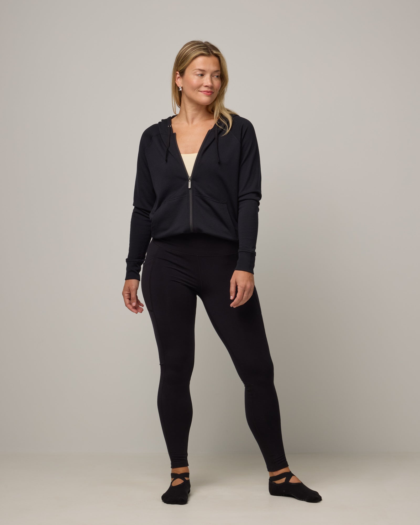 Model wearing Summit Pocket Legging in Black. Summit Pocket Legging is a merino wool legging with pockets available in sizes XS-3X Regular, S-XXL Long.