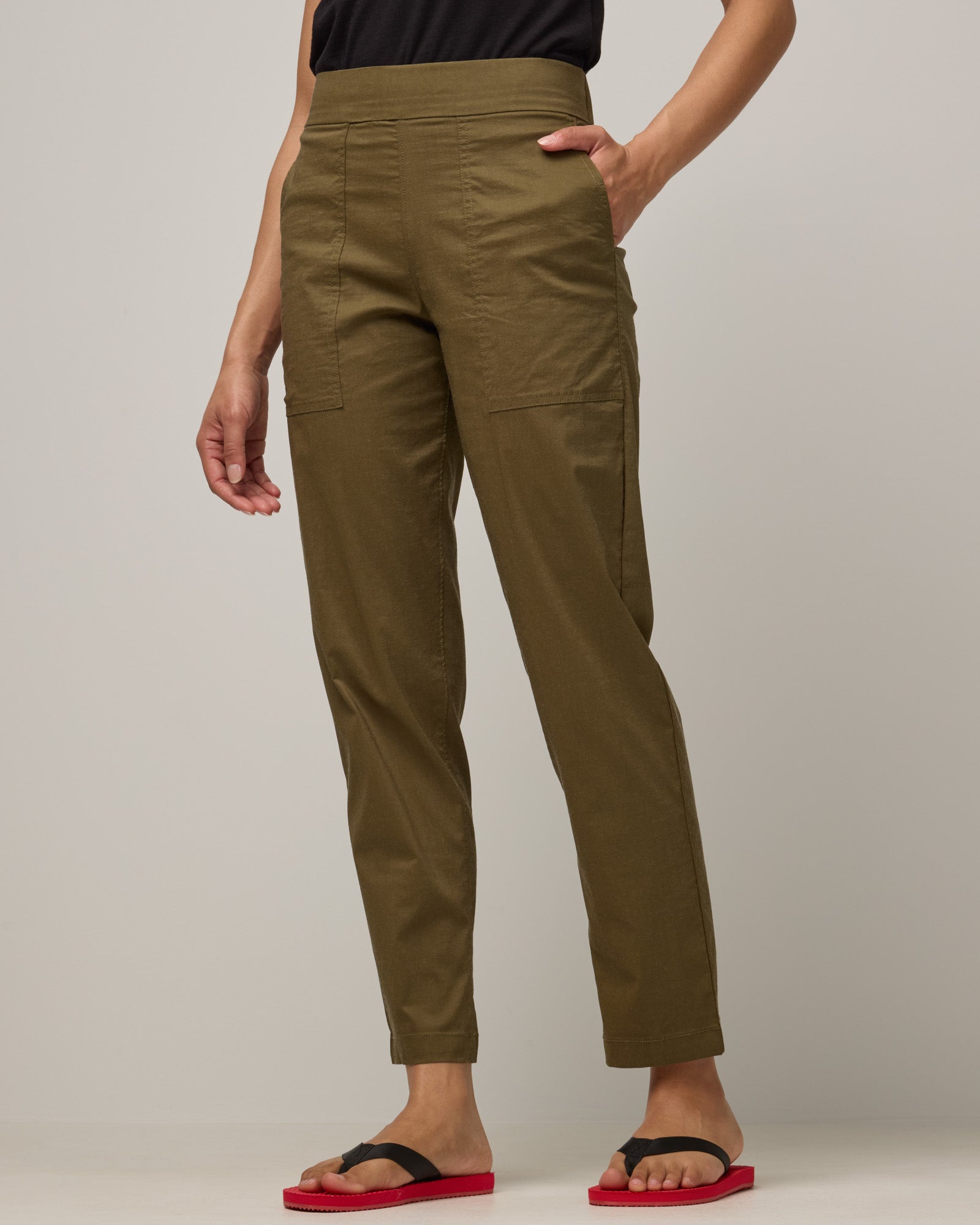 Model wearing Canyon Straight Leg Pant in Olive. Canyon Straight Leg Pant is a merino wool pant with pockets available in sizes XS-3X Regular and XS-XXL Long.