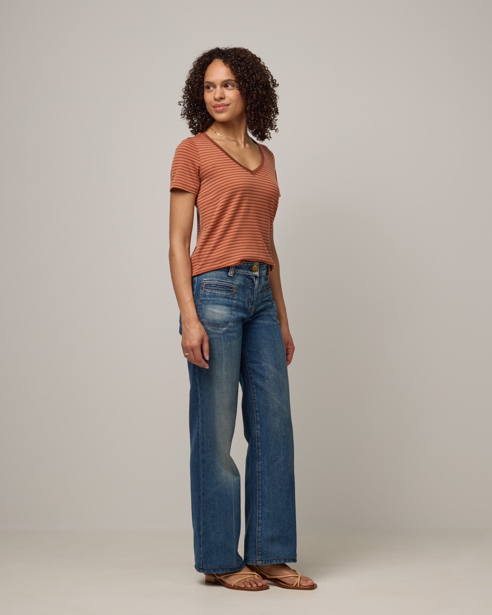 Model wearing Morgan V-Neck Tee in Tonal Cinnamon Stripe. Morgan V-Neck Tee is a merino wool short sleeve, v-neck, regular fit tee available in sizes XS-3X.