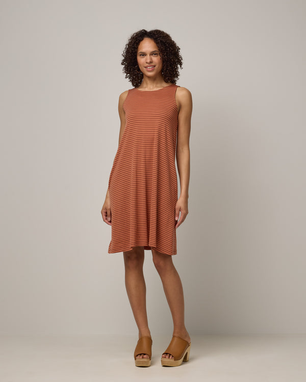 Model wearing Camellia Tank Dress in Cinnamon Tonal Stripe. Camellia Tank Dress is a merino wool sleeveless, crew neck, knee length swing dress with pockets available in sizes XS-3X Regular, XS-3X Long.