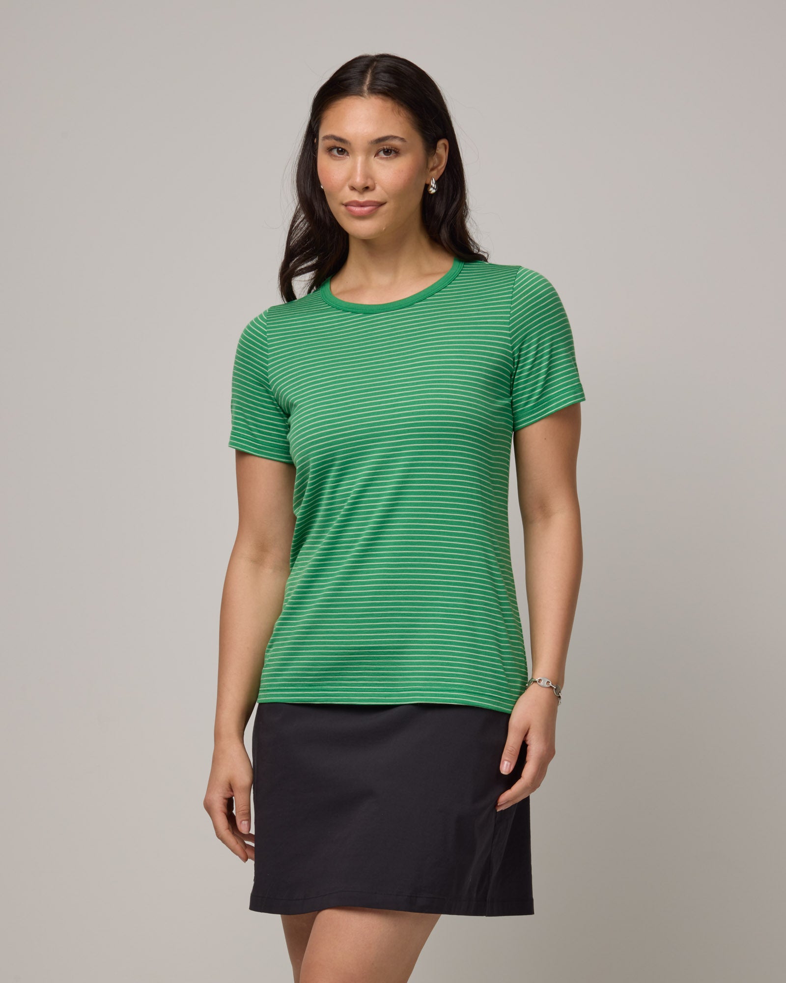 Model wearing Cara Signature Fitted Tee in Verde & Natural White Stripe. Cara Signature Fitted Tee is a merino wool short sleeve, crew neck, slim fit tee available in sizes XS-3X.
