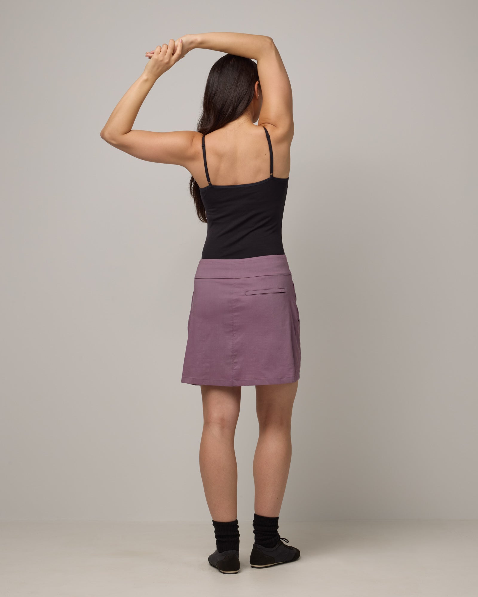 Model wearing Adventure Skort in Lavender. Adventure Skort is a merino wool above-knee length skort with pockets available in sizes XS-XXL.