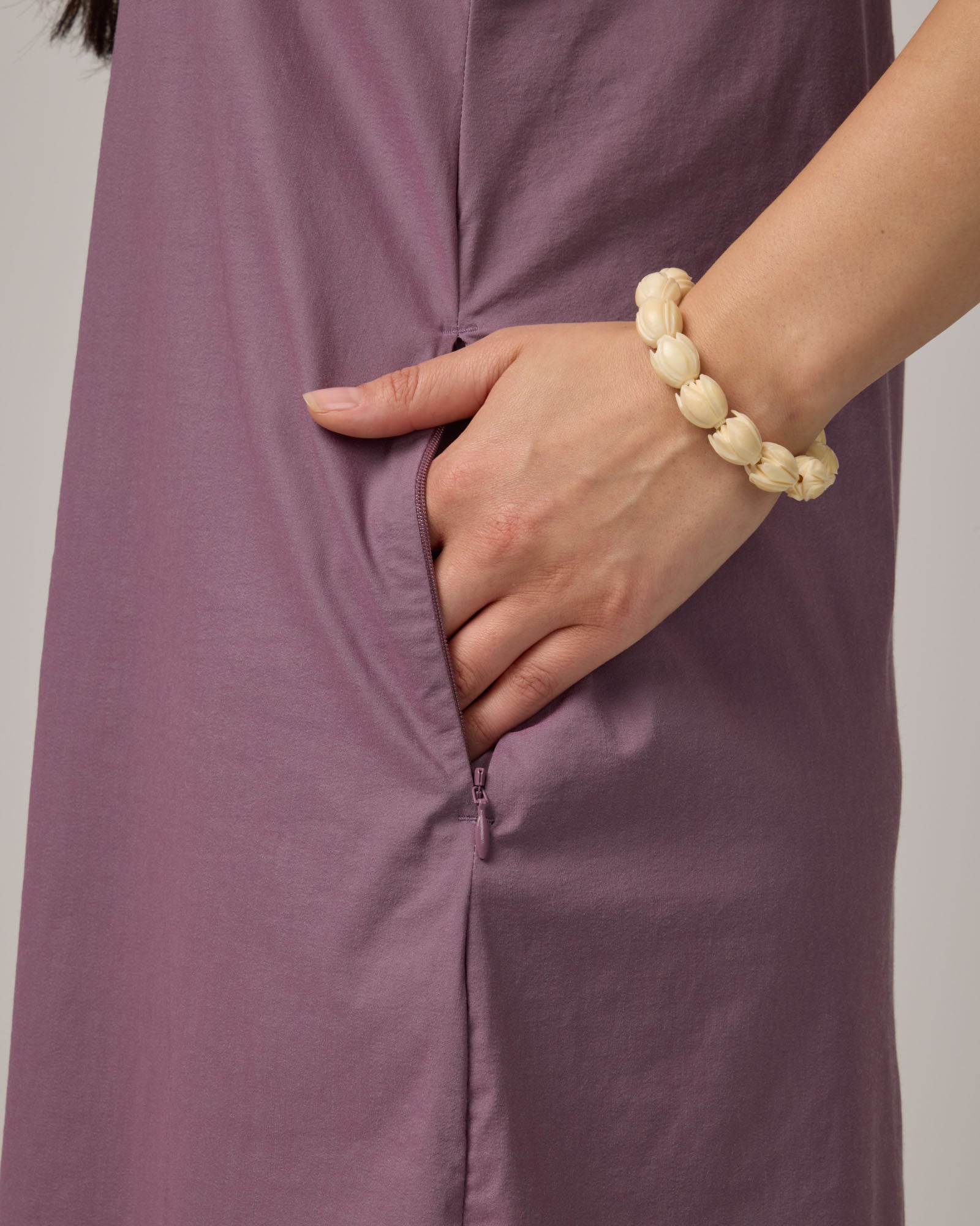 Pocket detail of Acadia Racerback Dress in Lavender. Acadia Racerback Dress is a merino wool sleeveless, v-neck, midi length fitted dress available in sizes XS-XXL.