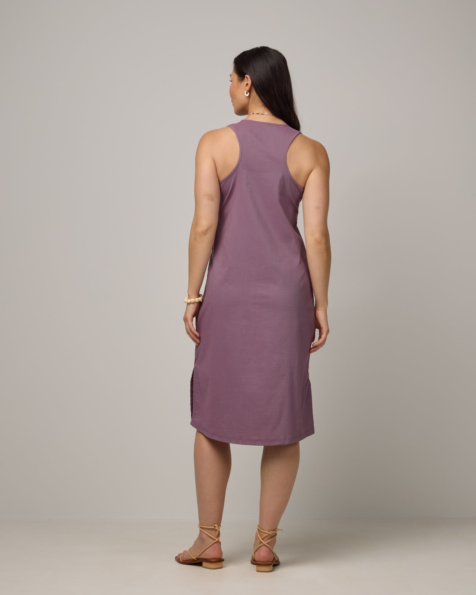 Model wearing Acadia Racerback Dress in Lavender. Acadia Racerback Dress is a merino wool sleeveless, v-neck, midi length fitted dress available in sizes XS-XXL.