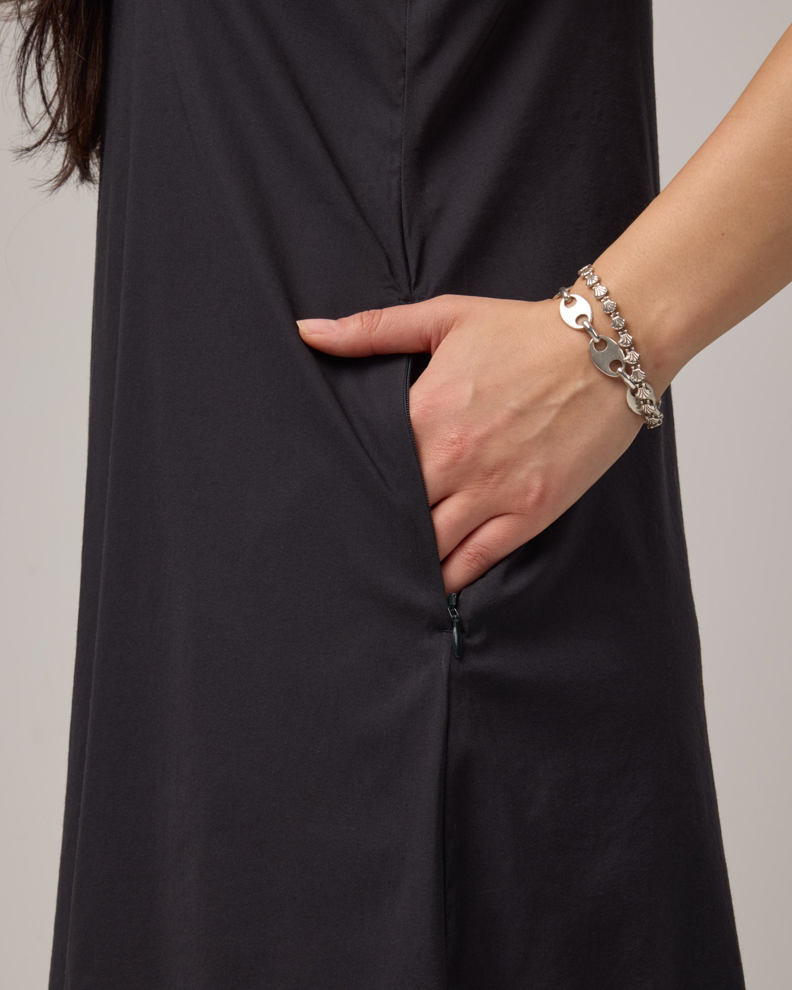 Pocket detail of Acadia Racerback Dress in Black. Acadia Racerback Dress is a merino wool sleeveless, v-neck, midi length fitted dress available in sizes XS-XXL.