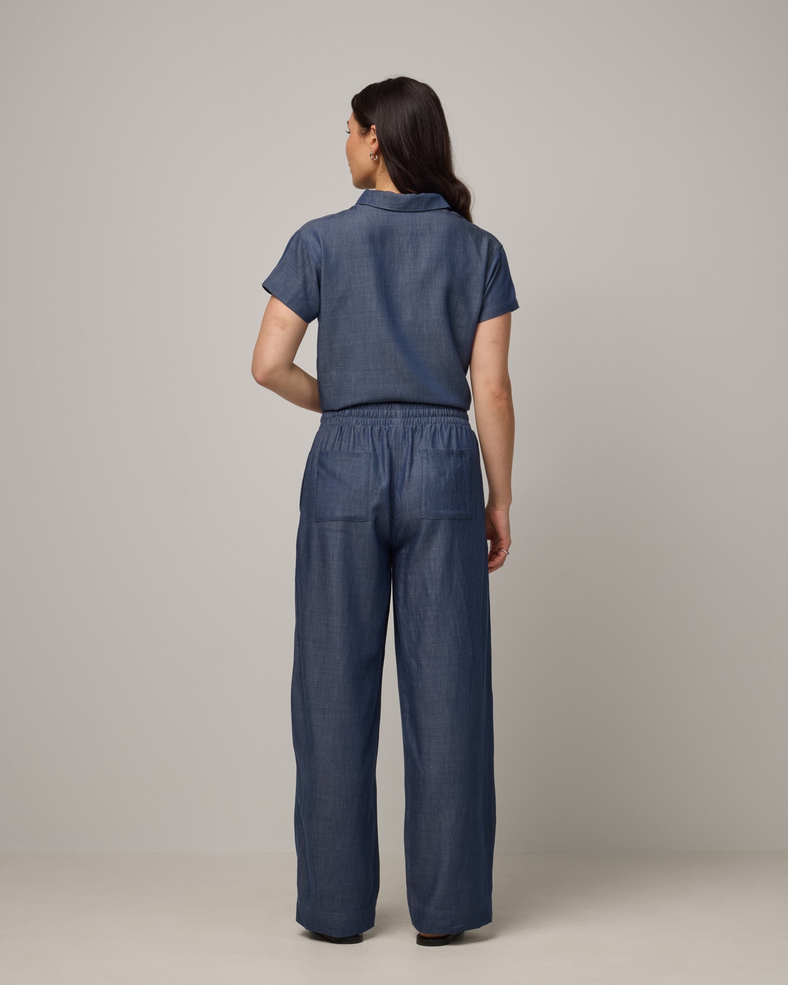Model wearing Erin Chambray Pant in Dark Blue. Erin Chambray Pant is a merino wool drawstring easy pant available in sizes XS-XXL. 