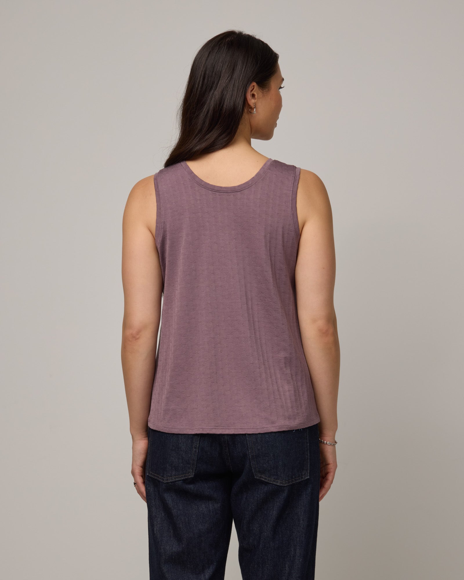 Model wearing Poppy Jacquard Reversible Tank in Lavender, a dusky muted purple color. Poppy Signature Reversible Tank is a merino wool sleeveless, reversible, relaxed fit top available in sizes XS-3X.