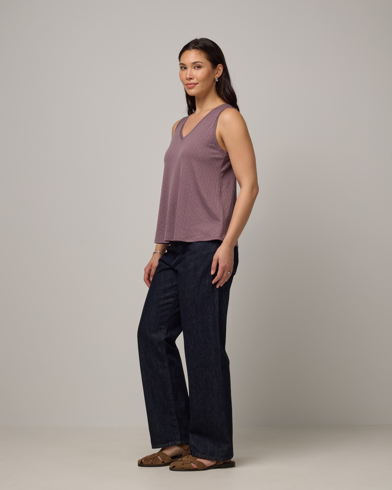 Model wearing Poppy Jacquard Reversible Tank in Lavender, a dusky muted purple color. Poppy Signature Reversible Tank is a merino wool sleeveless, reversible, relaxed fit top available in sizes XS-3X.
