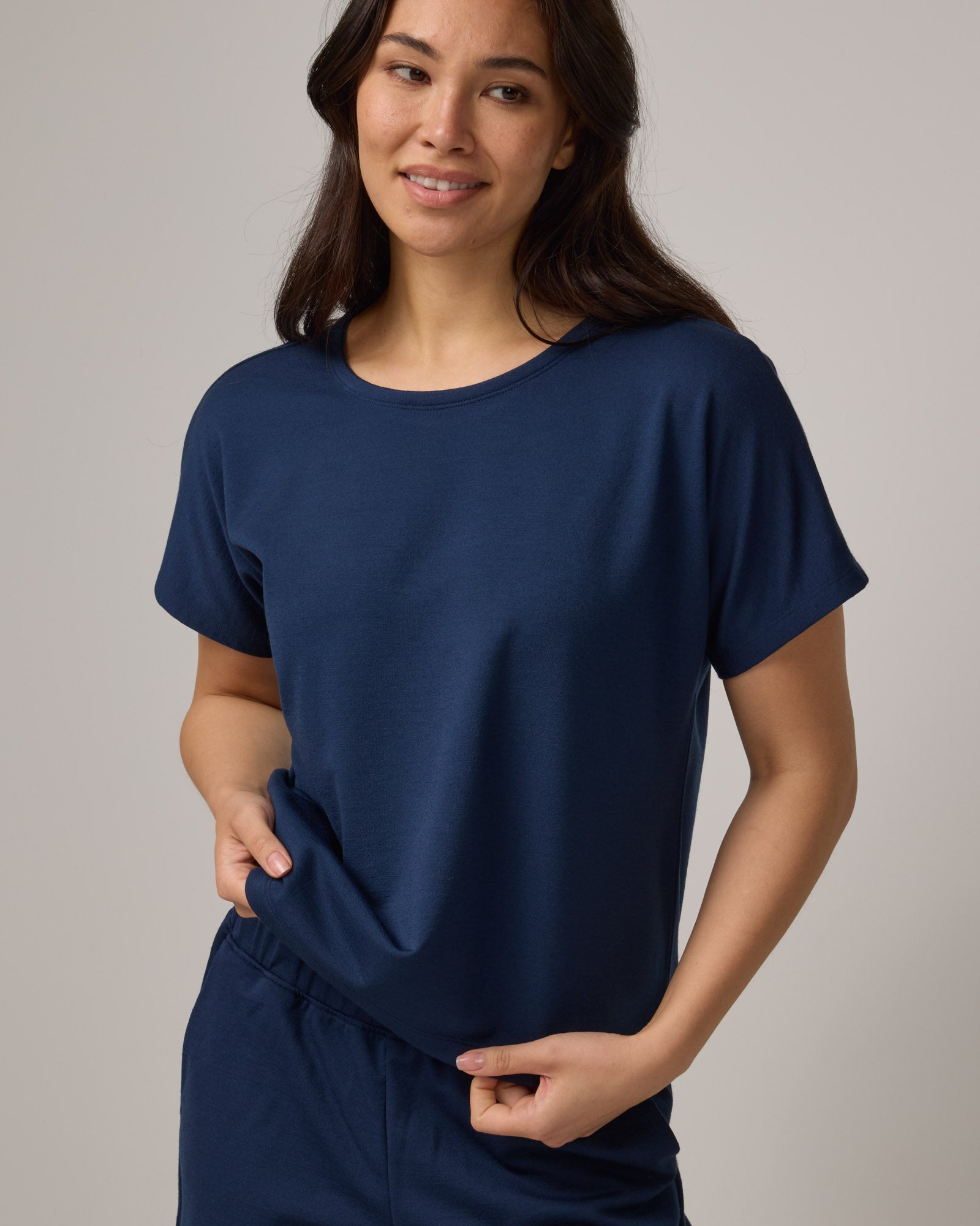 Model wearing Carina Sweatshirt Tee in Marine Blue, a deep royal blue color. Carina Sweatshirt Tee is a merino wool short sleeve, crew neck, relaxed fit boxy tee available in sizes XS-XXL.