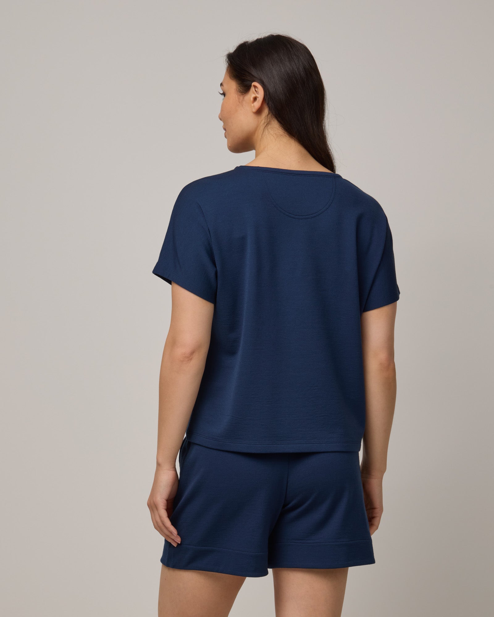 Model wearing Carina Sweatshirt Tee in Marine Blue, a deep royal blue color. Carina Sweatshirt Tee is a merino wool short sleeve, crew neck, relaxed fit boxy tee available in sizes XS-XXL.