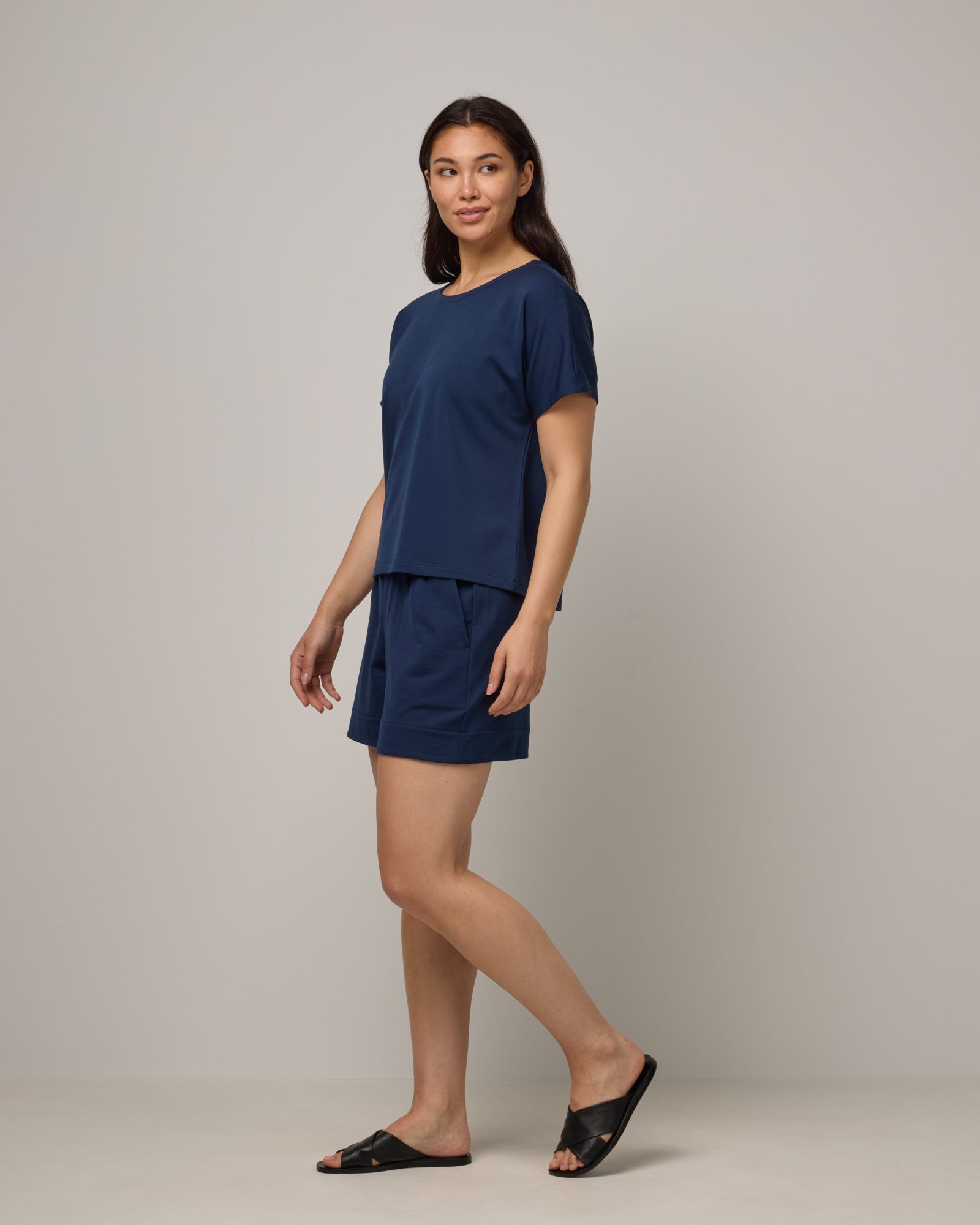 Model wearing Carina Sweatshirt Tee in Marine Blue, a deep royal blue color. Carina Sweatshirt Tee is a merino wool short sleeve, crew neck, relaxed fit boxy tee available in sizes XS-XXL.