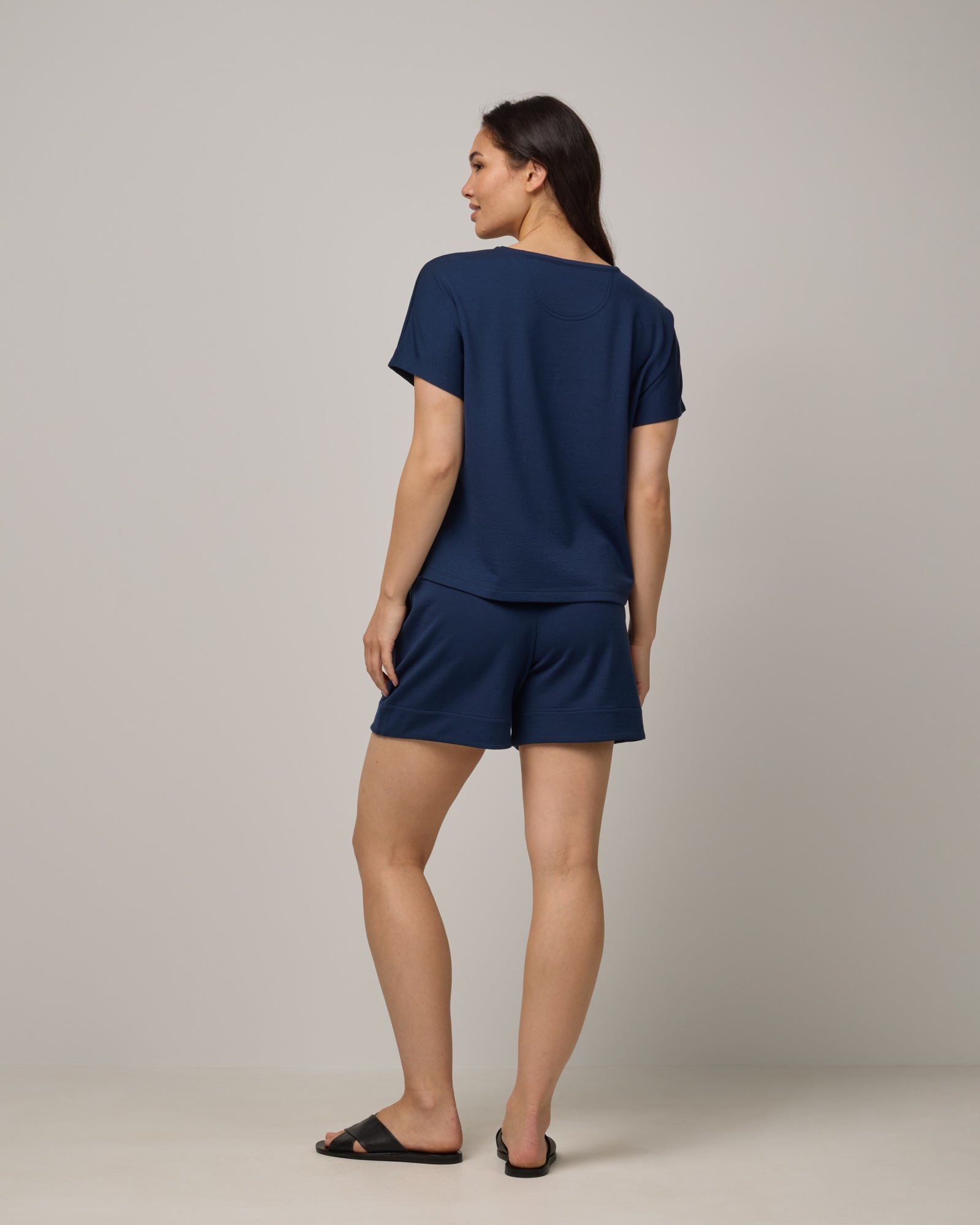Model wearing Carina Sweatshirt Tee in Marine Blue, a deep royal blue color. Carina Sweatshirt Tee is a merino wool short sleeve, crew neck, relaxed fit boxy tee available in sizes XS-XXL.