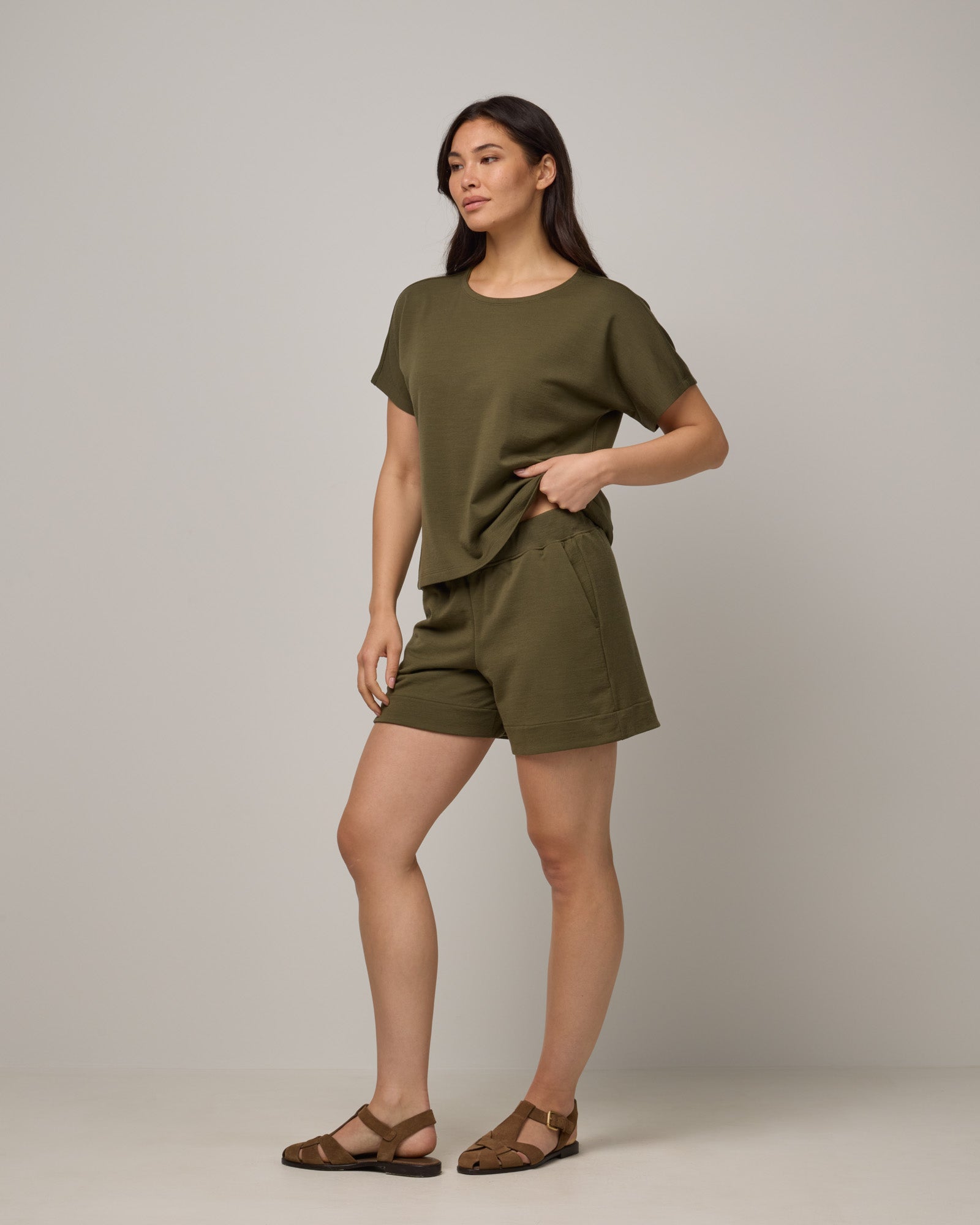 Model wearing Aspen Short in Olive. Aspen Short is a merino wool sweat short with 5in inseam available in sizes XS-XXL.