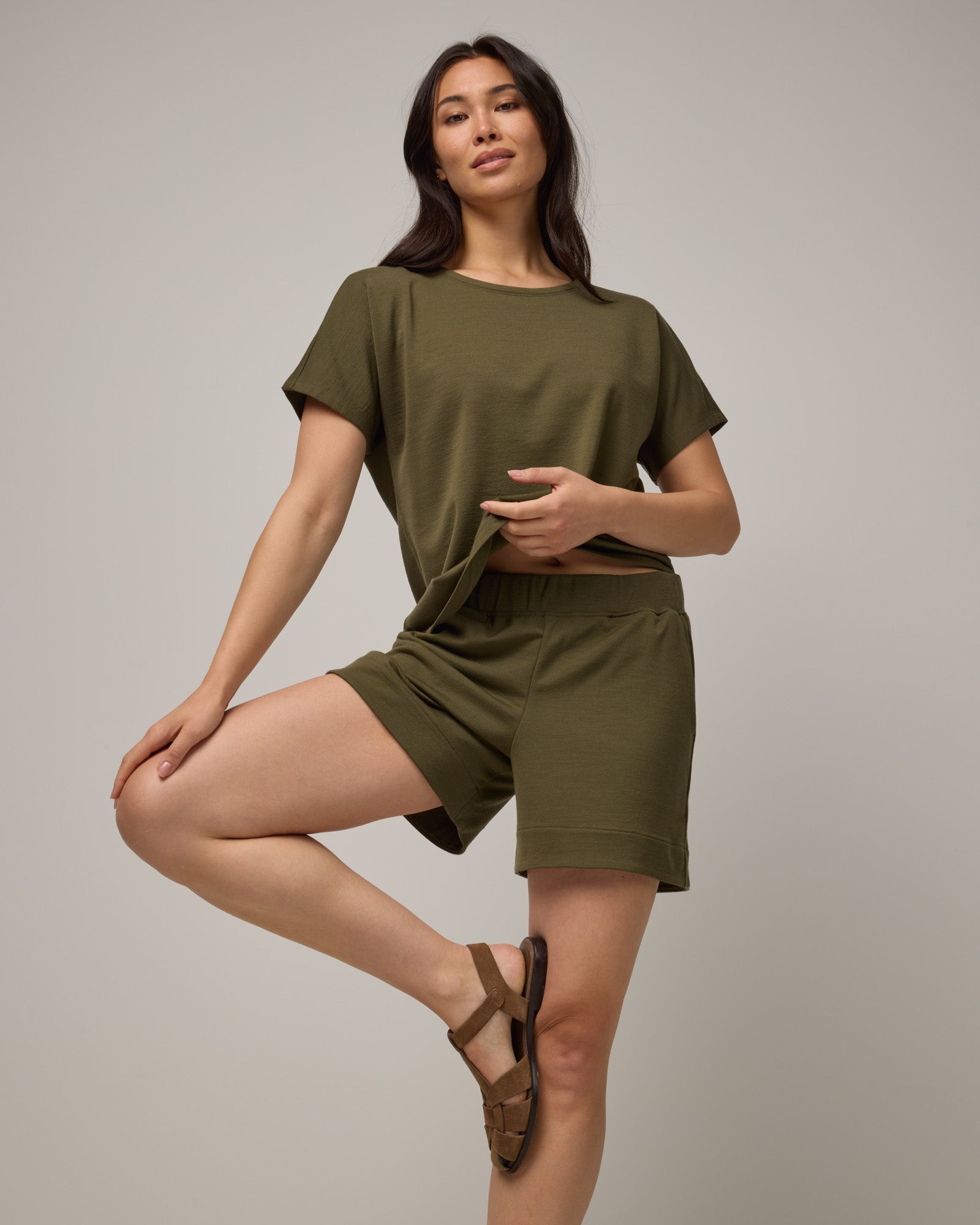 Model wearing Aspen Short in Olive. Aspen Short is a merino wool sweat short with 5in inseam available in sizes XS-XXL.