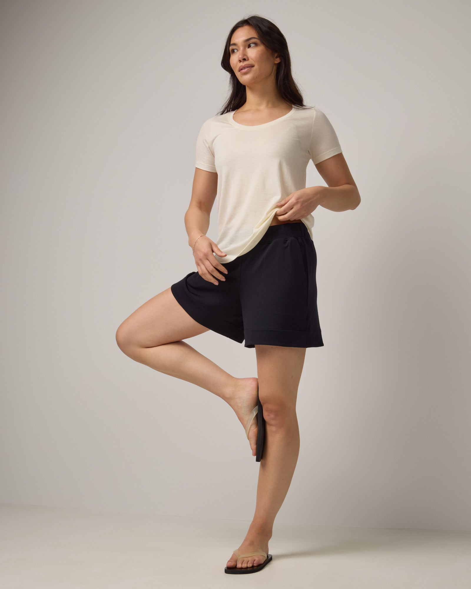 Model wearing Aspen Short in Black. Aspen Short is a merino wool sweat short with 5in inseam available in sizes XS-XXL.
