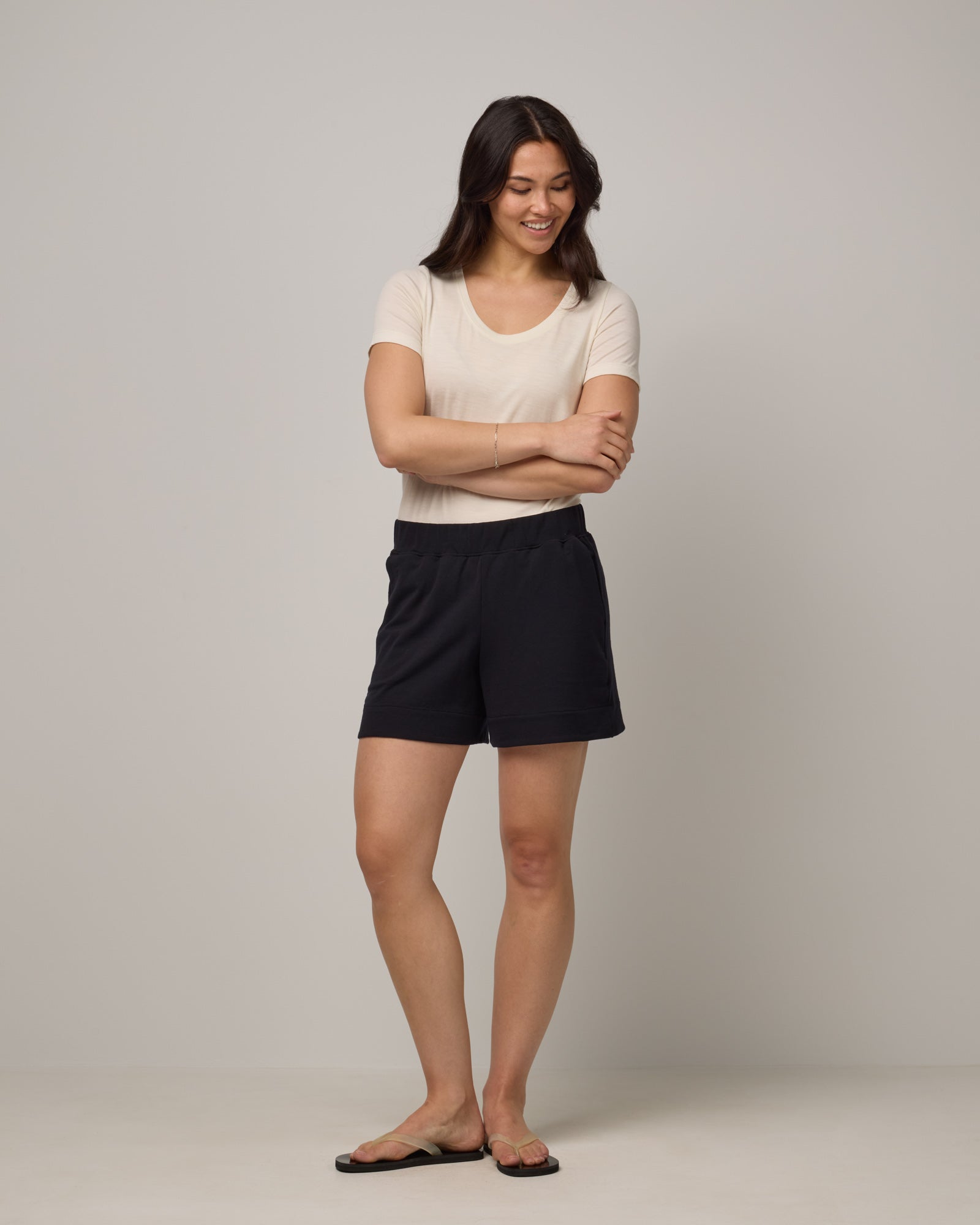 Model wearing Aspen Short in Black. Aspen Short is a merino wool sweat short with 5in inseam available in sizes XS-XXL.
