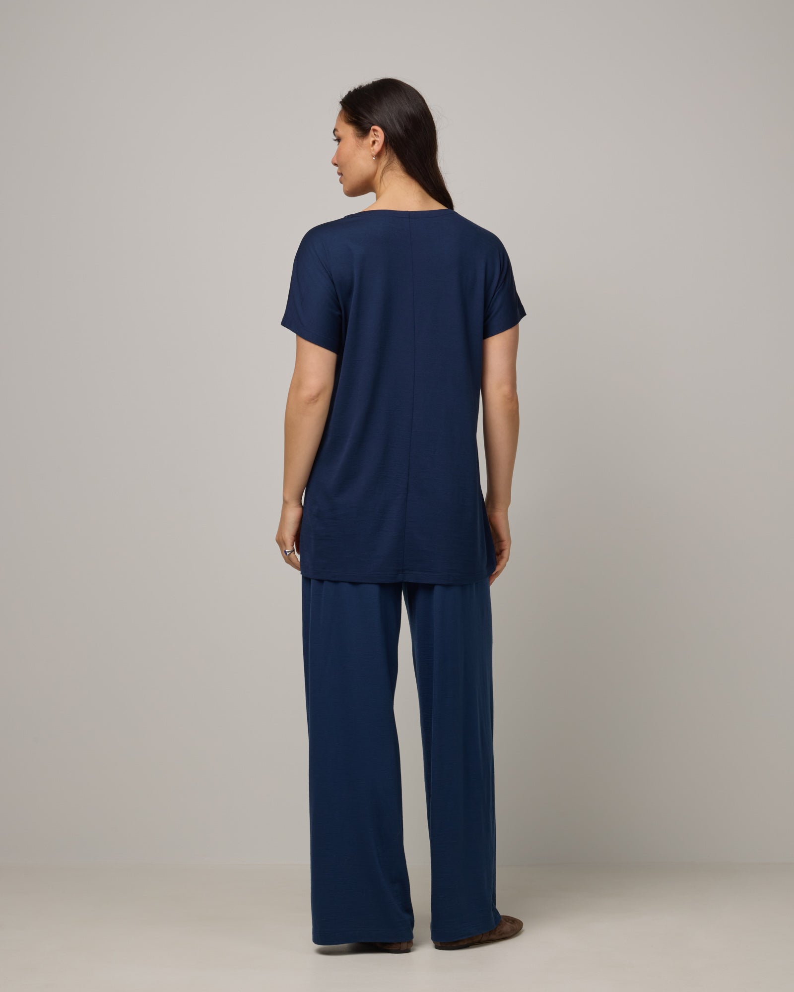 Model wearing Jade Tunic Tee in Marine Blue, a deep royal blue color. Jade Tunic Tee is a merino wool short sleeve, crew neck, relaxed fit tunic available in sizes XS-3X.