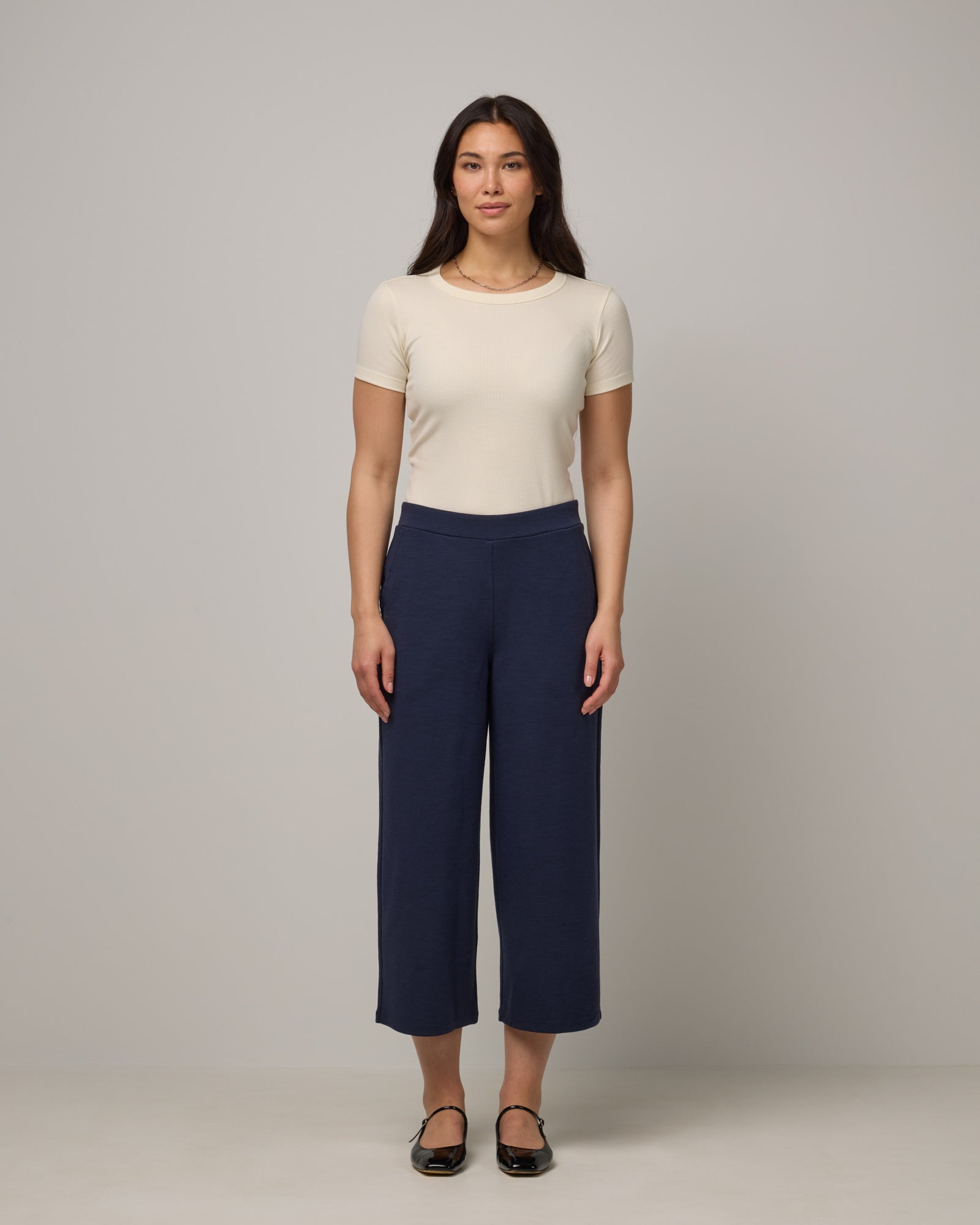 Model wearing Frame Ponte Culotte in Washed Navy. Frame Ponte Culotte is a merino wool pant with pockets available in sizes XS-3X Regular, XS-XL Petite.