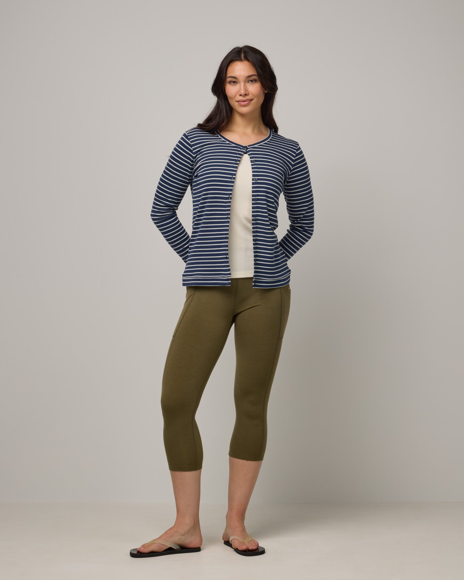 Model wearing Summit Pocket Crop Legging in Olive. Summit Pocket Crop Legging is a merino wool legging with pockets available in sizes XS-3X.