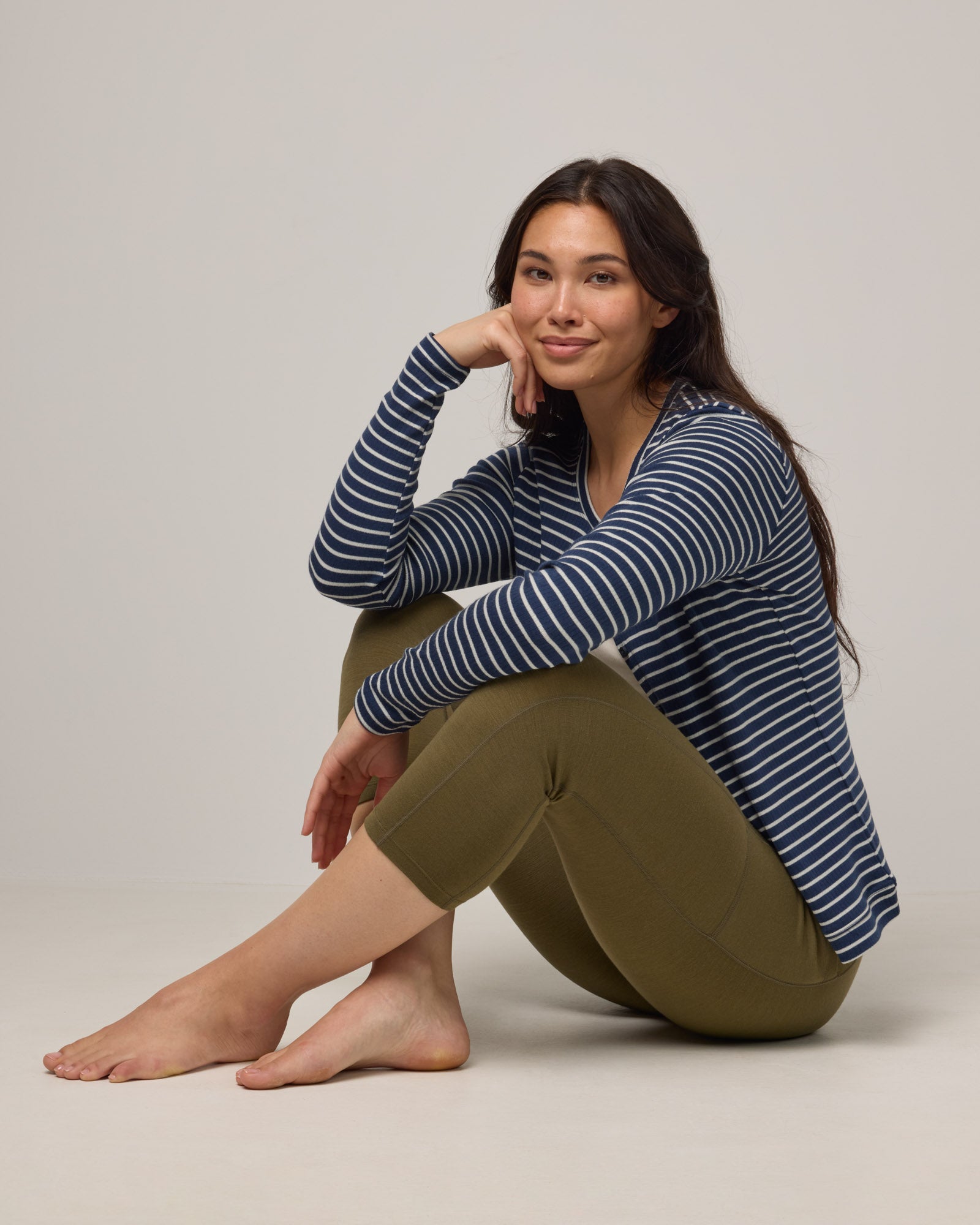 Model wearing Summit Pocket Crop Legging in Olive. Summit Pocket Crop Legging is a merino wool legging with pockets available in sizes XS-3X.