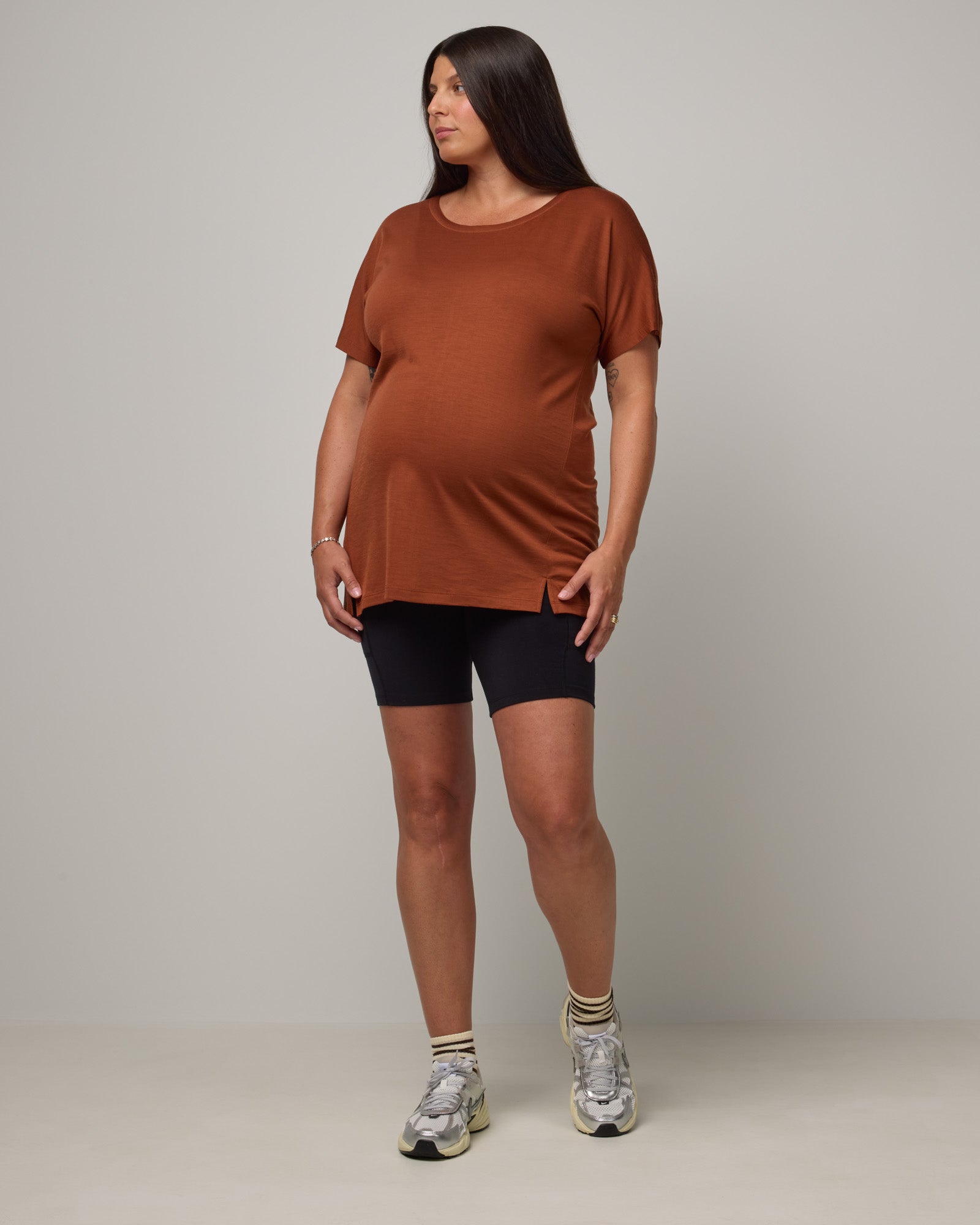 Model wearing Summit Maternity Pocket Bike Short in Black. Summit Maternity Pocket Bike Short is a merino wool bike short with side pockets available in sizes XS-3X.