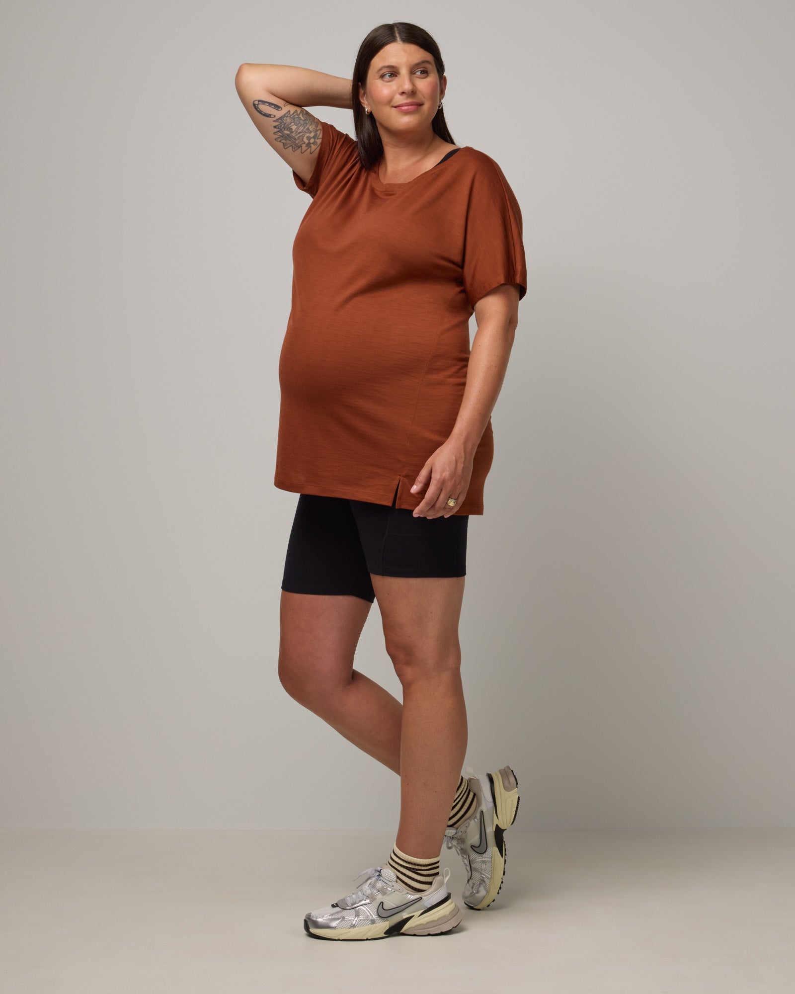 Model wearing Summit Maternity Pocket Bike Short in Black. Summit Maternity Pocket Bike Short is a merino wool bike short with side pockets available in sizes XS-3X.