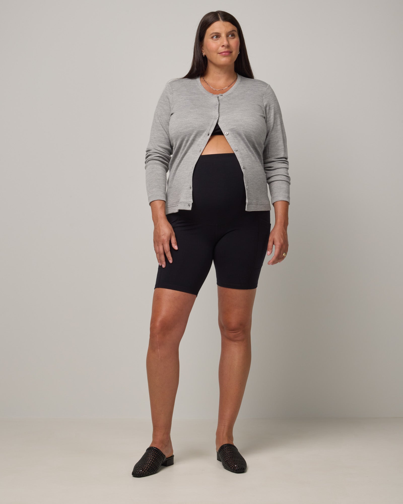 Model wearing Summit Maternity Pocket Bike Short in Black. Summit Maternity Pocket Bike Short is a merino wool bike short with side pockets available in sizes XS-3X.