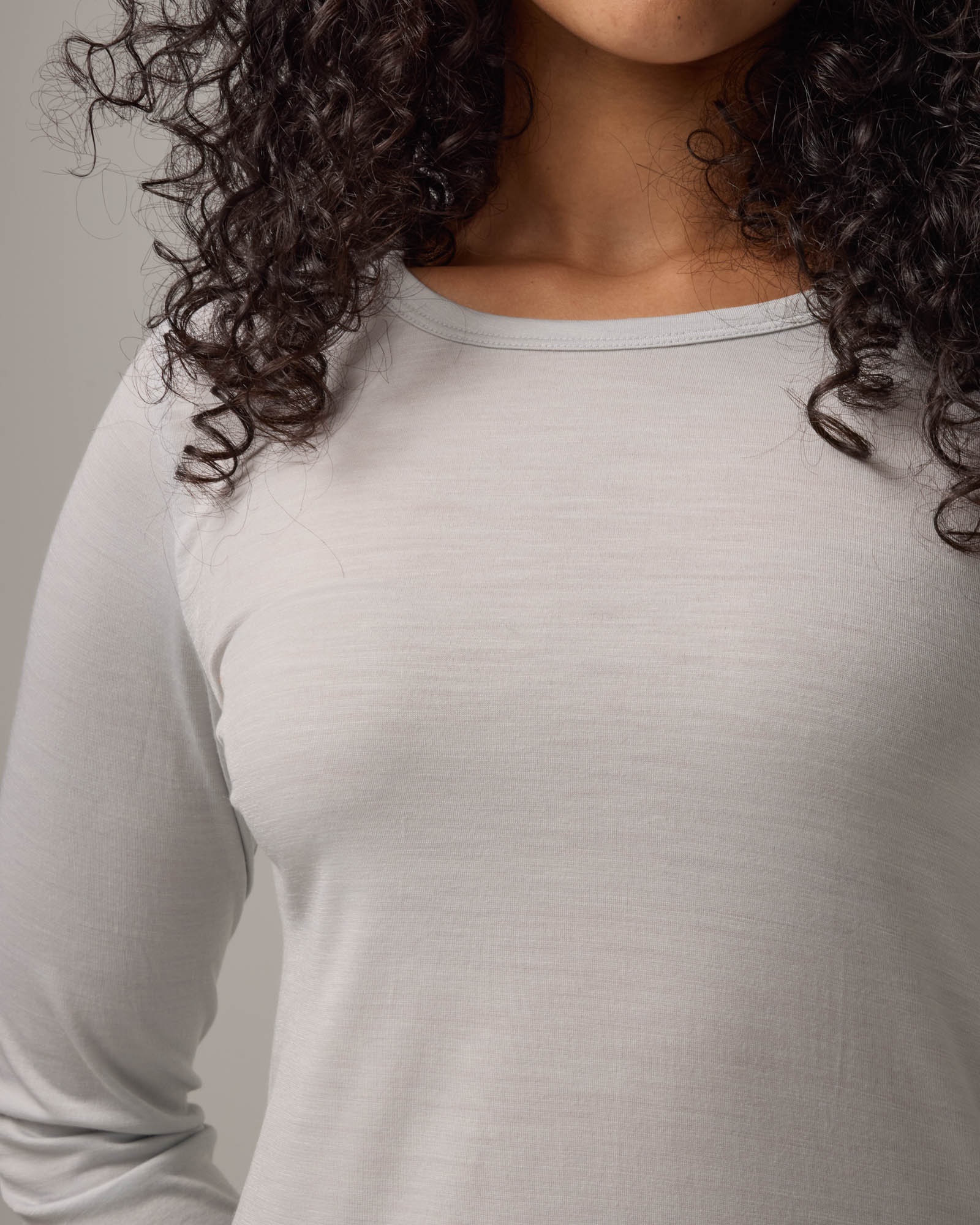 Model wearing Sloan Signature Fitted Tee in Light Gray End-on-End. Sloan Signature Fitted Tee is a merino wool long sleeve, crew neck, slim fit tee available in sizes XS-3X.